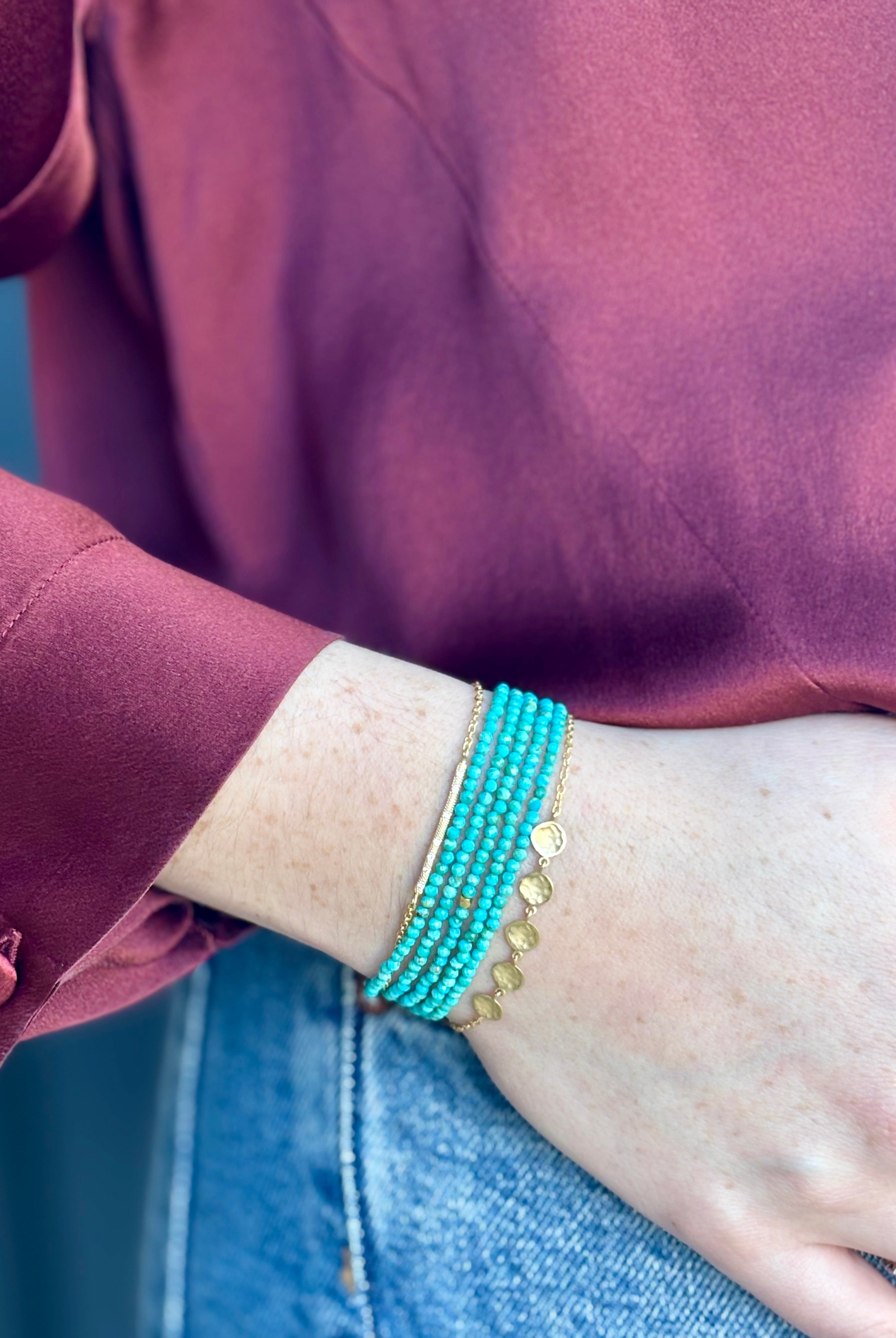Image of woman wearing Canadian fine Jewelry designer ANNE SPORTUN Bracelet stack with 18K Yellow Gold, diamonds, and turquoise