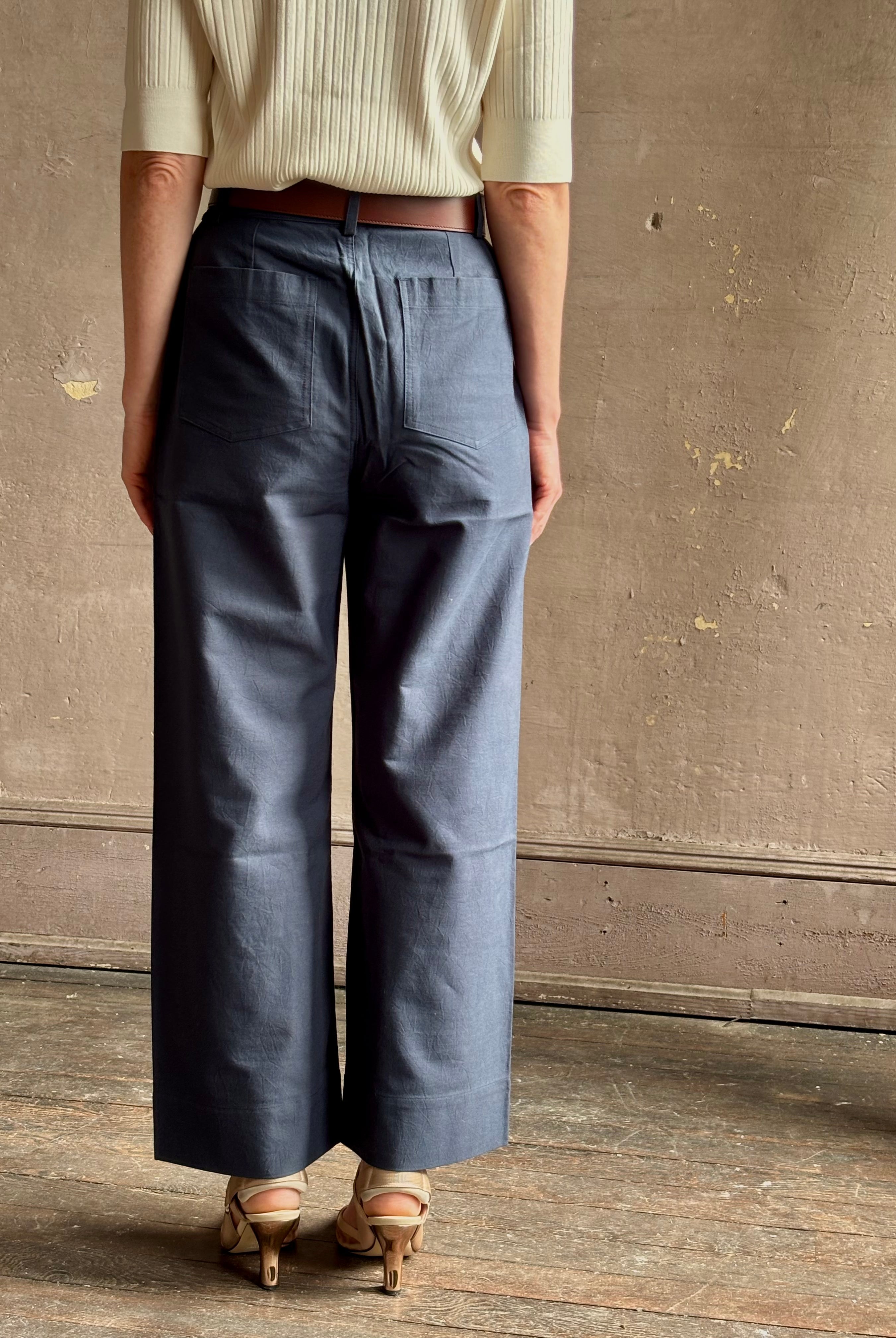mature woman wearing apiece apart merida slim wide leg pant oganic cotton high rise button and zipper flat front