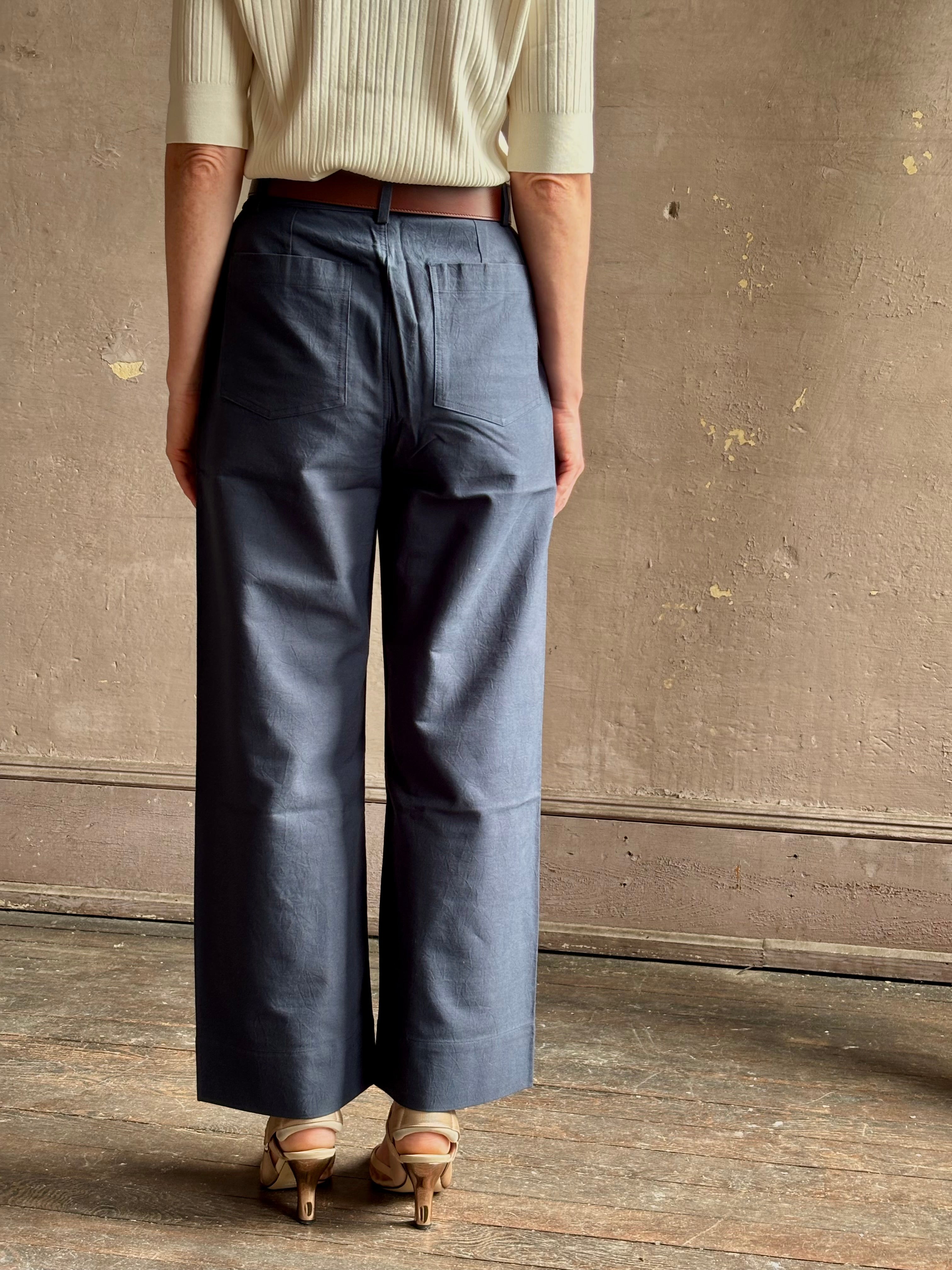 mature woman wearing apiece apart merida slim wide leg pant oganic cotton high rise button and zipper flat front