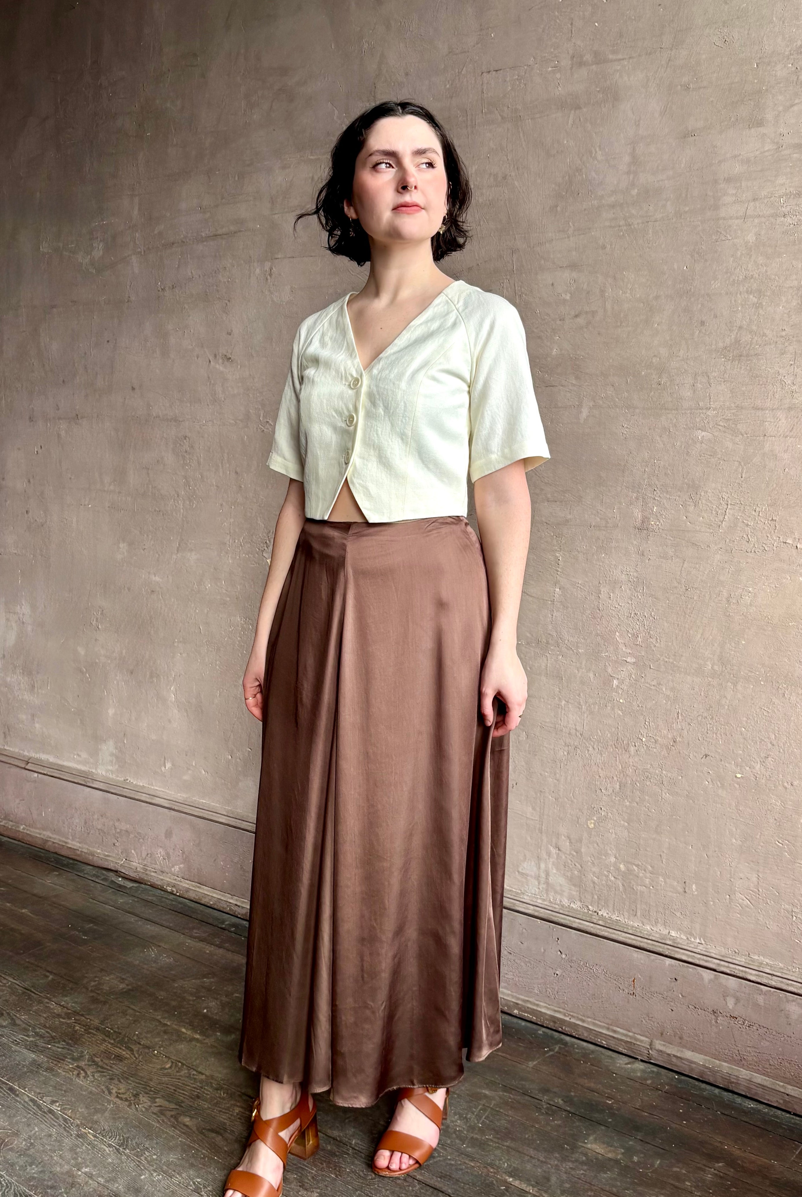 Woman wearing an elevated cream Lia designer Crop Top from Apiece Apart crafted in a breathable summer blend of organic cotton and linen