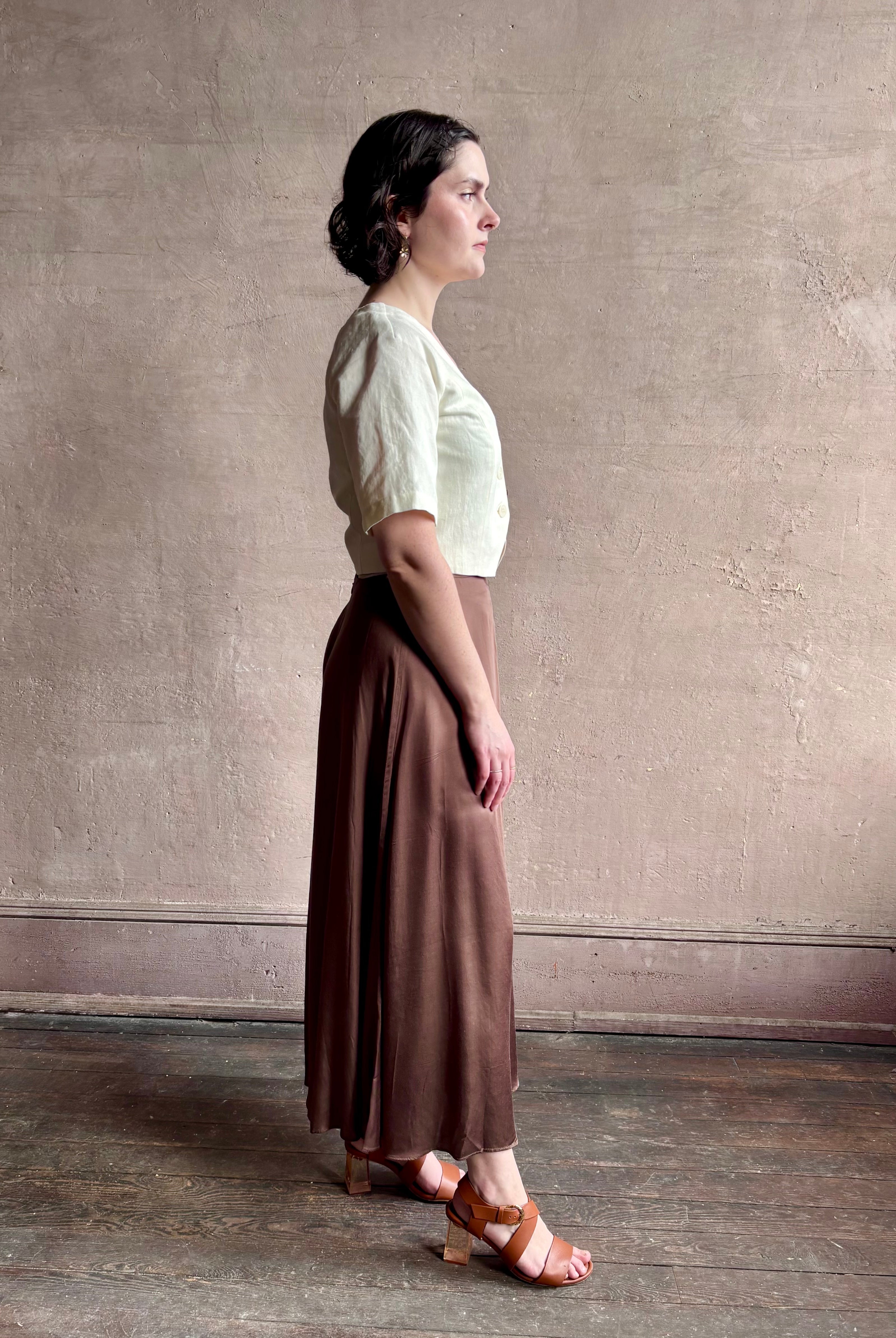 Woman wearing an elevated cream Lia designer Crop Top from Apiece Apart crafted in a breathable summer blend of organic cotton and linen