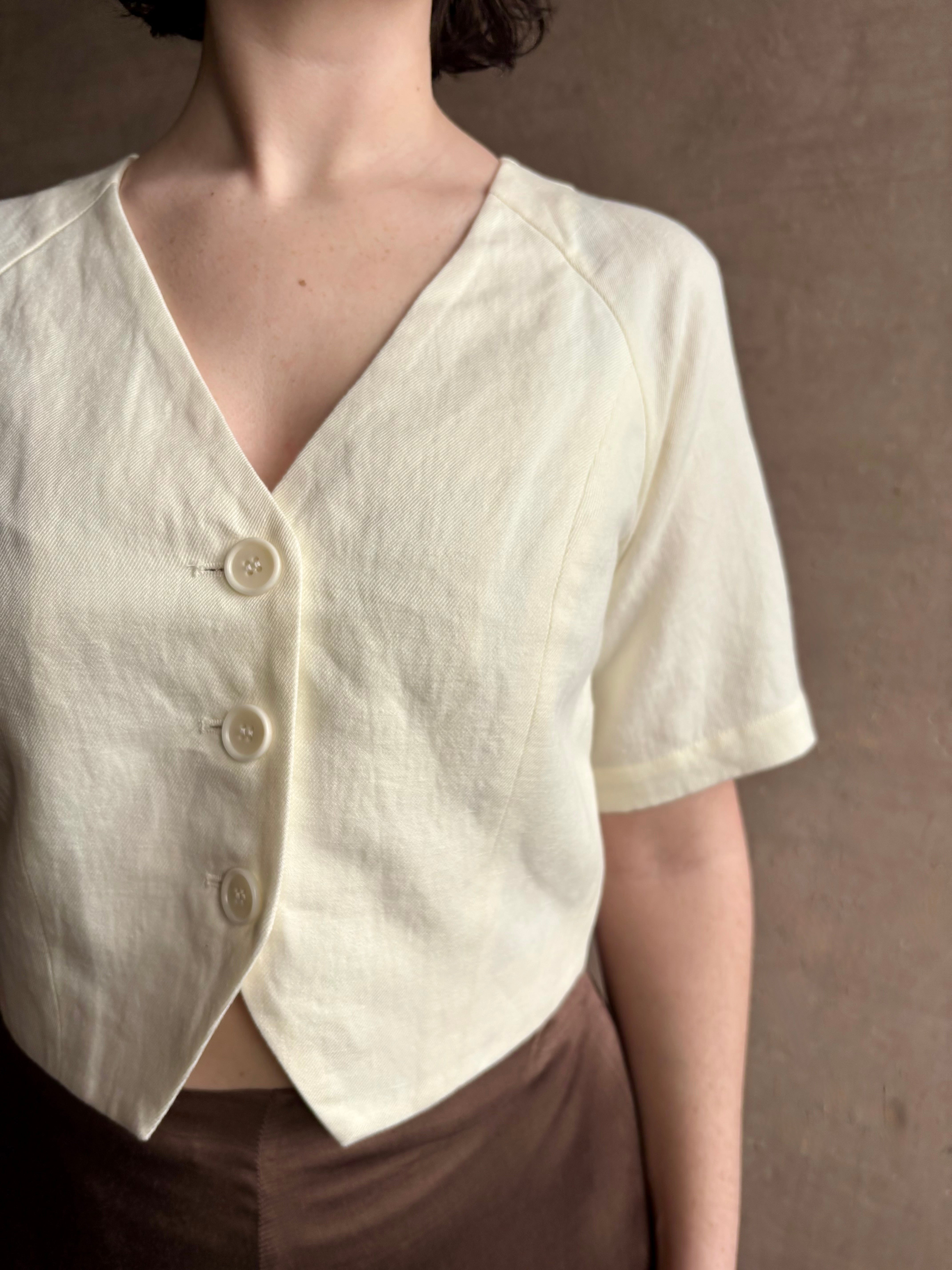 Woman wearing an elevated cream Lia designer Crop Top from Apiece Apart crafted in a breathable summer blend of organic cotton and linen