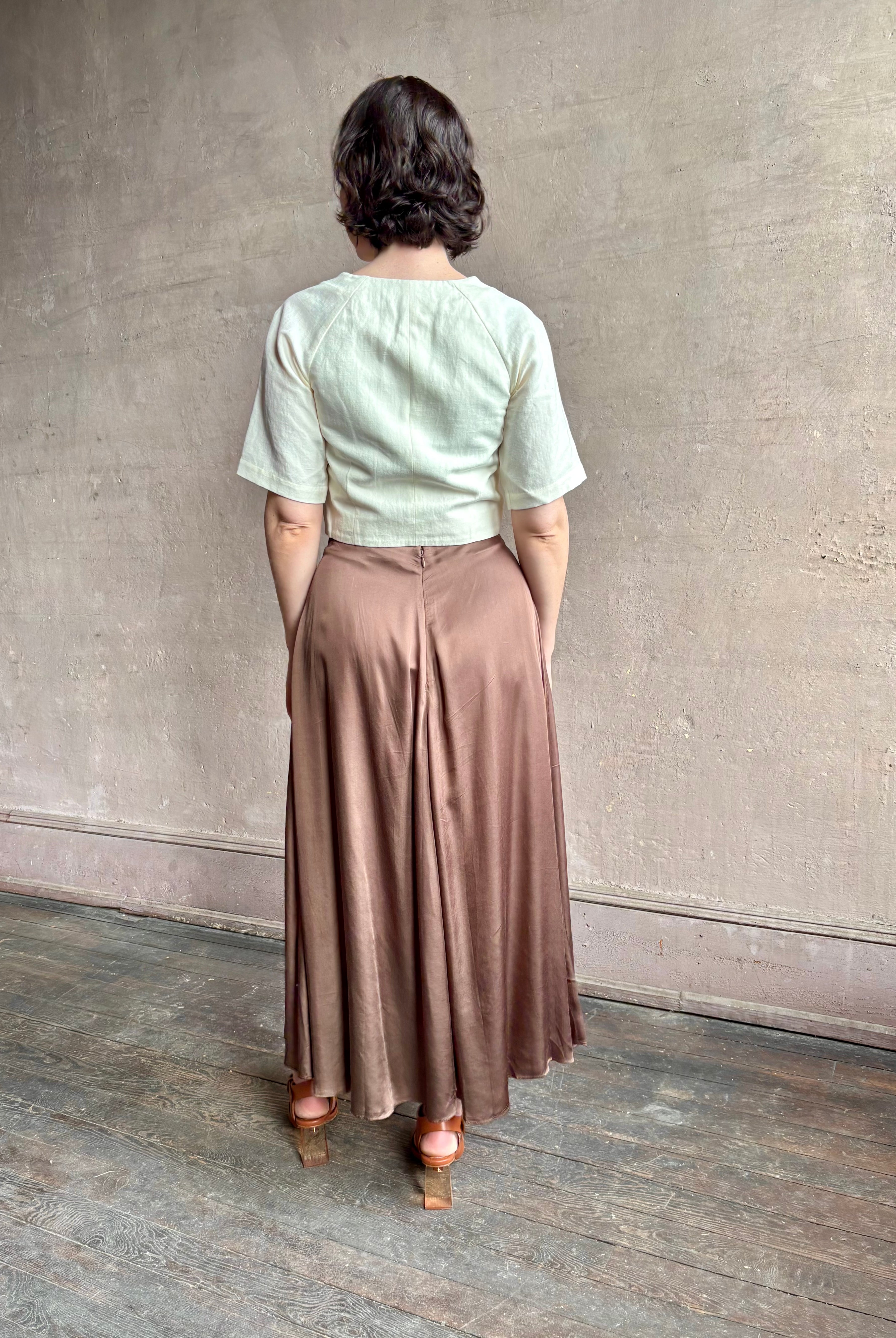 Woman wearing an elevated cream Lia designer Crop Top from Apiece Apart crafted in a breathable summer blend of organic cotton and linen