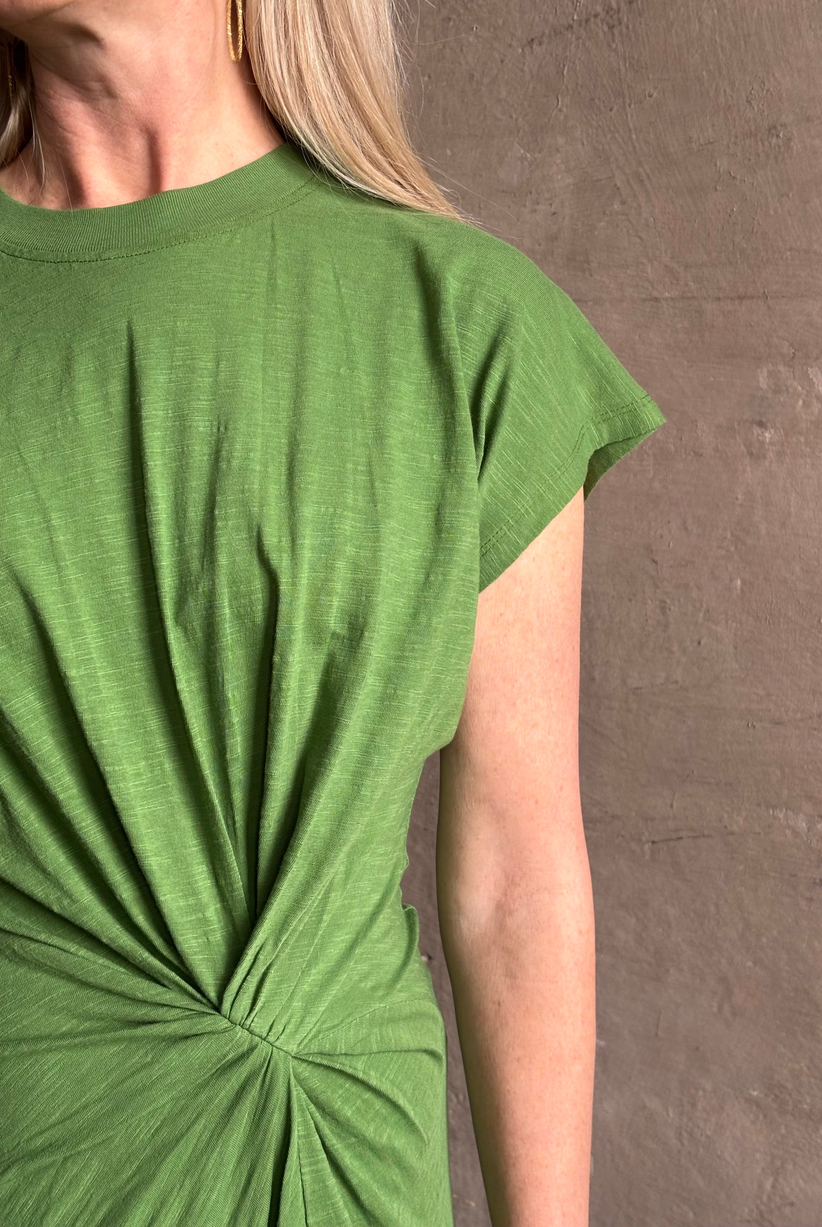 Mature woman wearing Volta Twist maxi Dress from Apiece Apart in a comfy green organic cotton jersey with short sleeves and crew neck