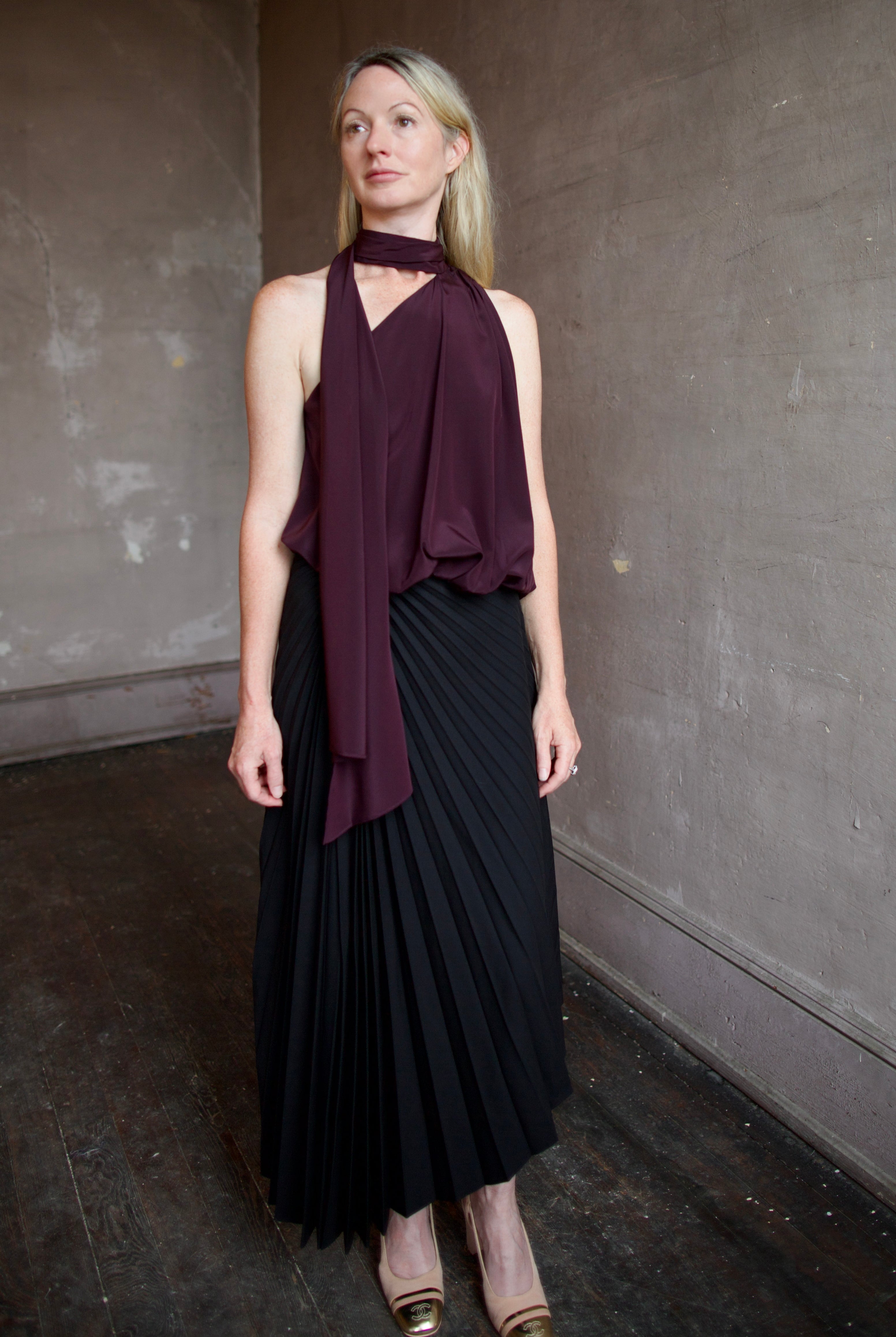 Mature model wearing the pleated tracy skirt and celeste top by ALC for a sophisticated date night outfit