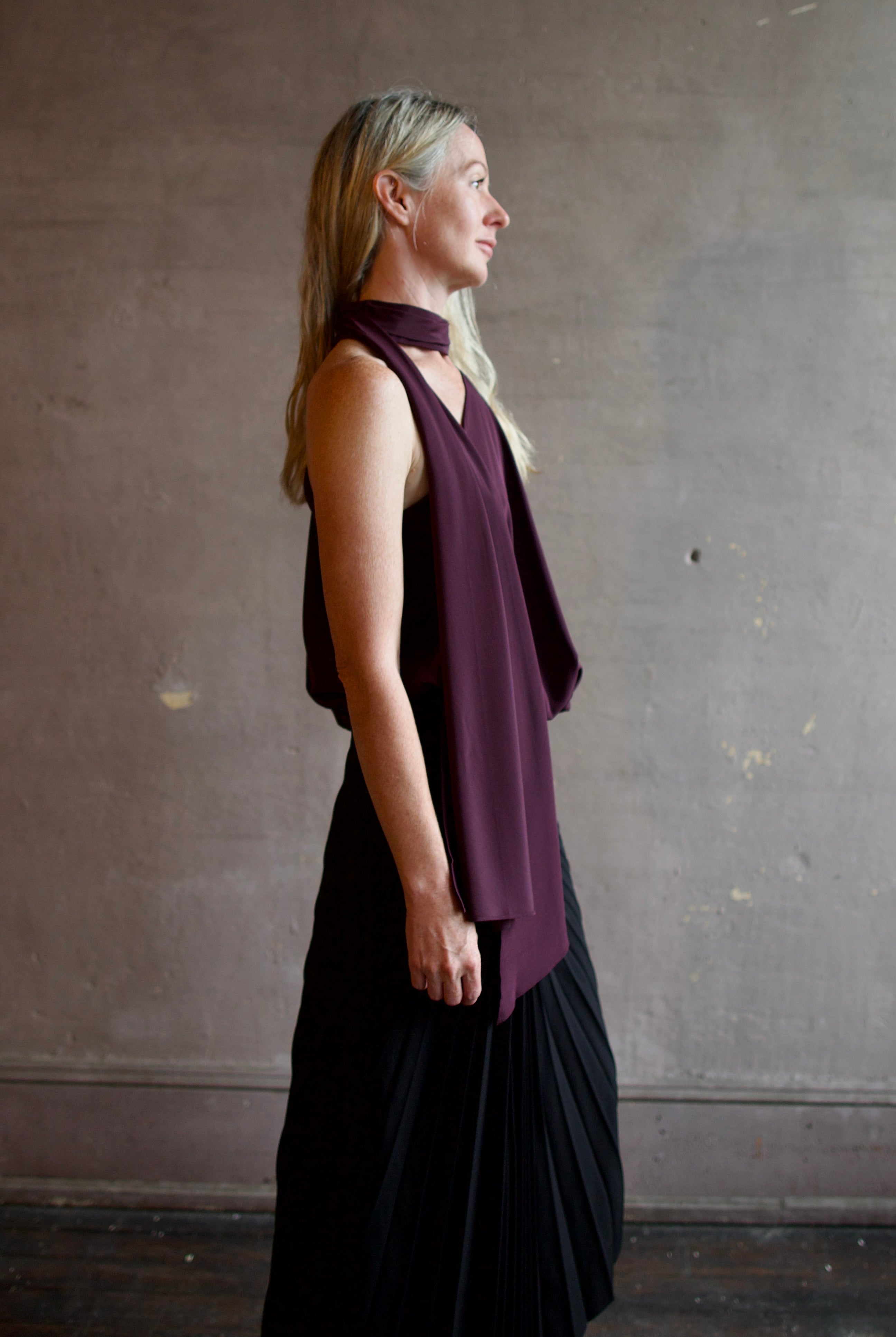 Profile image of model wearing the asymmetrical silk celeste top by ALC with attached sophisticated scarf detail