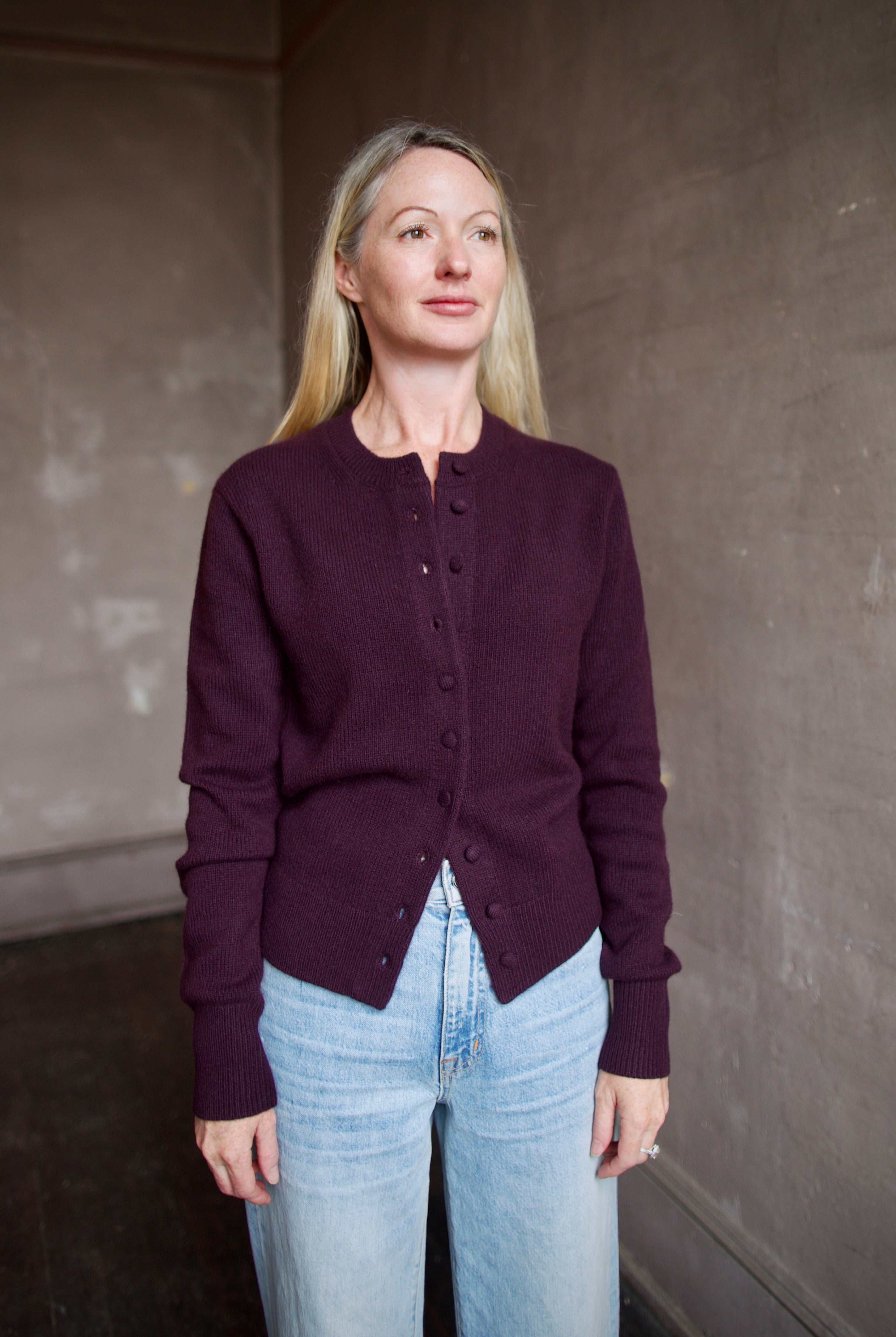 Mature model wearing a purple cashmere cardigan by ALC with covered buttons as an elevated basic