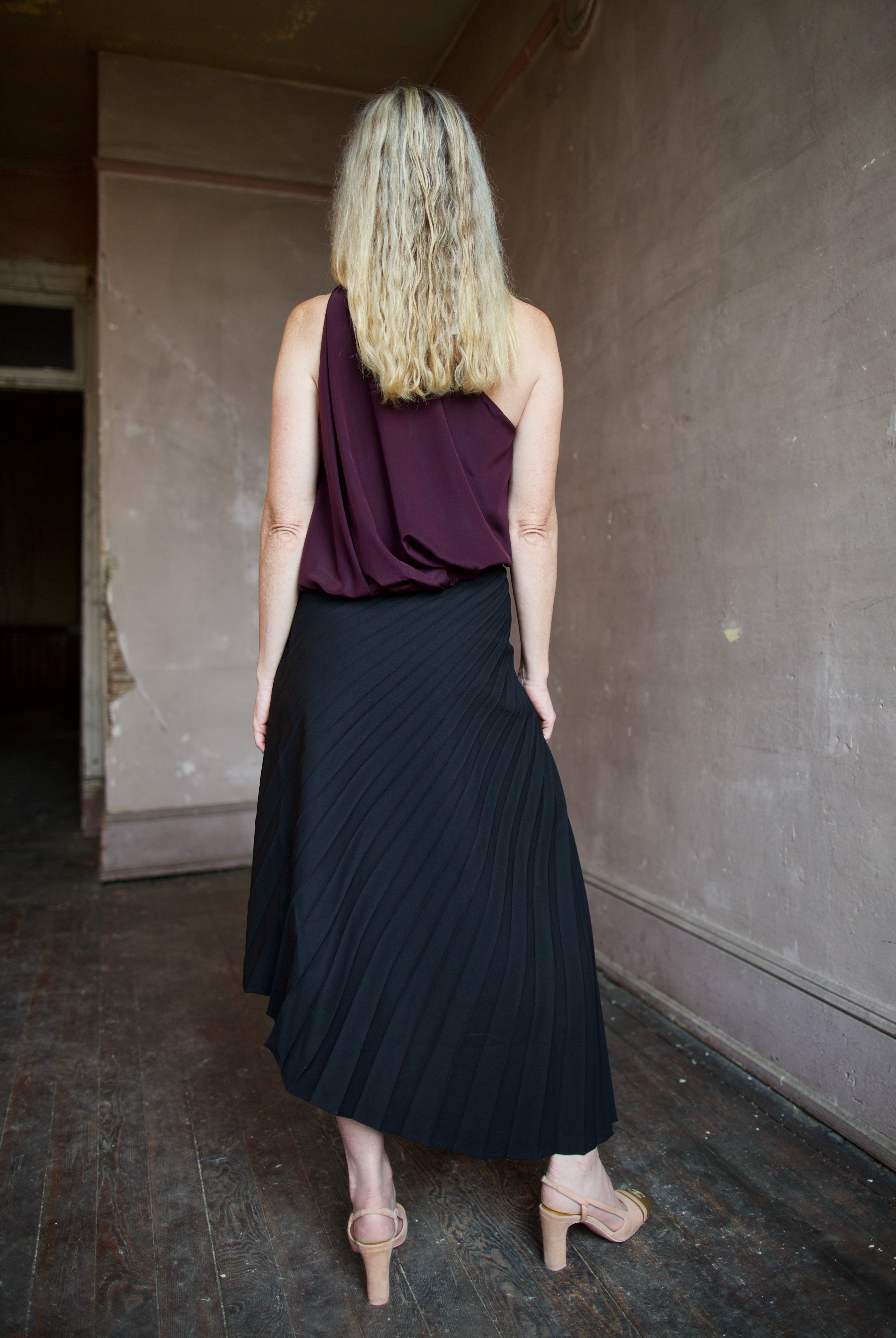Mature model wearing the pleated tracy skirt and celeste top by ALC for a sophisticated date night outfit