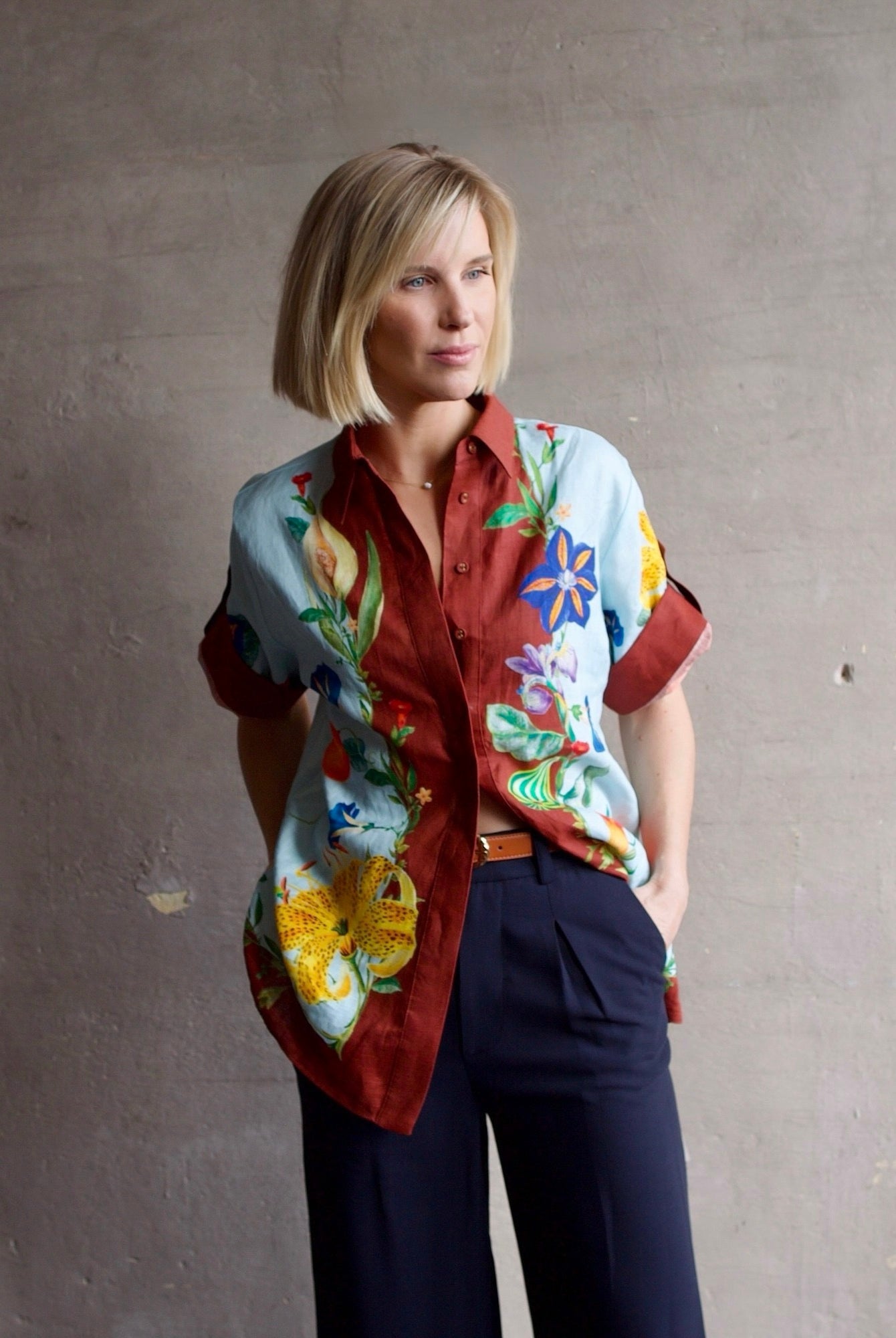 Image of a woman wearing the Alemais Dahlia top, Ulla Johnson Gia Belt and Apiece Apart Cara Wide leg trousers.