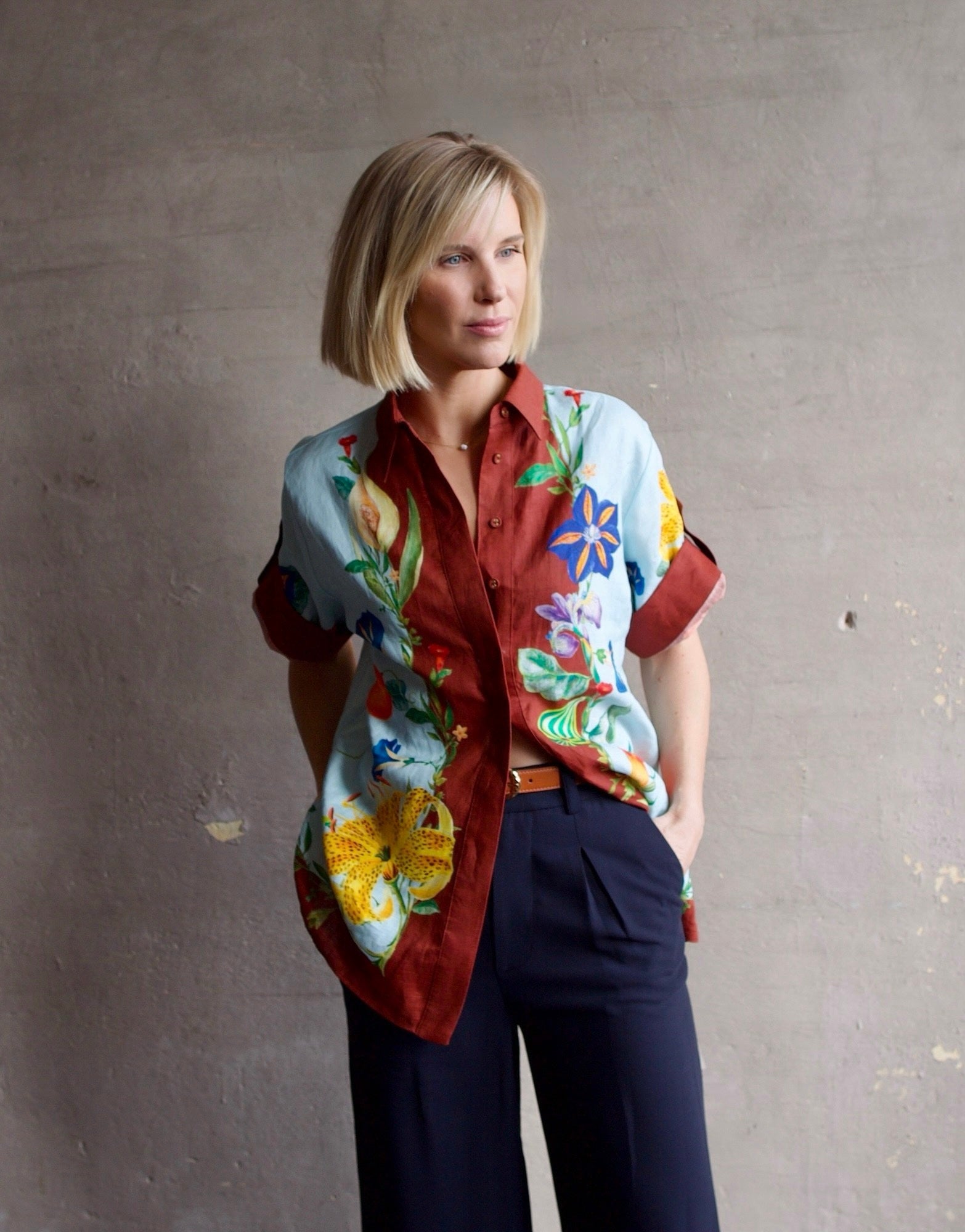 Image of a woman wearing the Alemais Dahlia top, Ulla Johnson Gia Belt and Apiece Apart Cara Wide leg trousers.