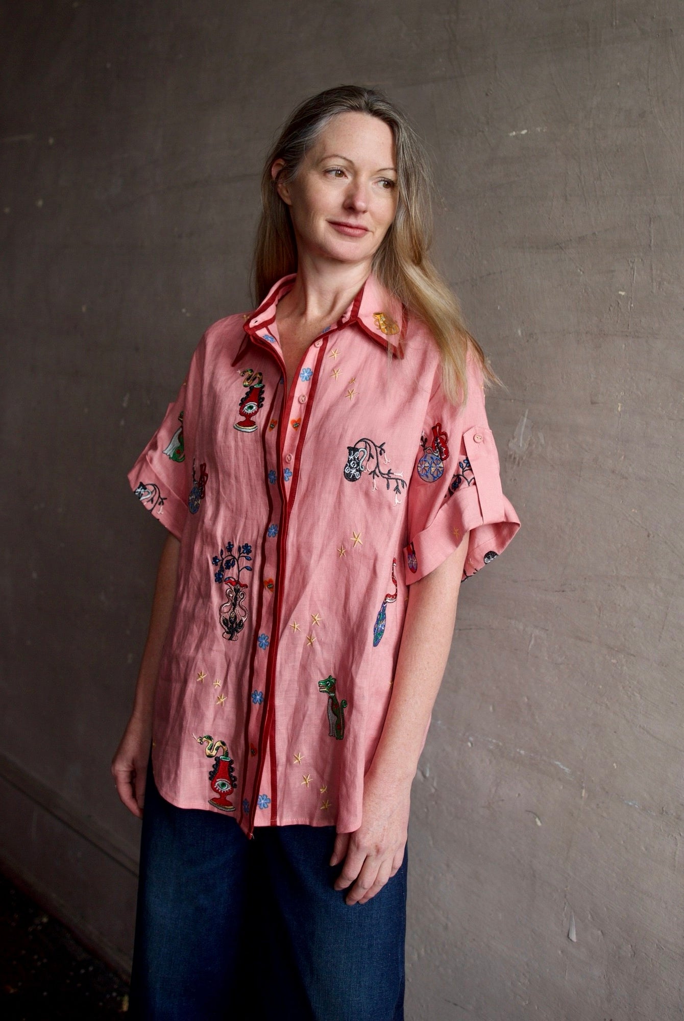 Image of a woman wearing the Alemais Timmy embroidered shirt and Re/Done Wide Leg crop jeans