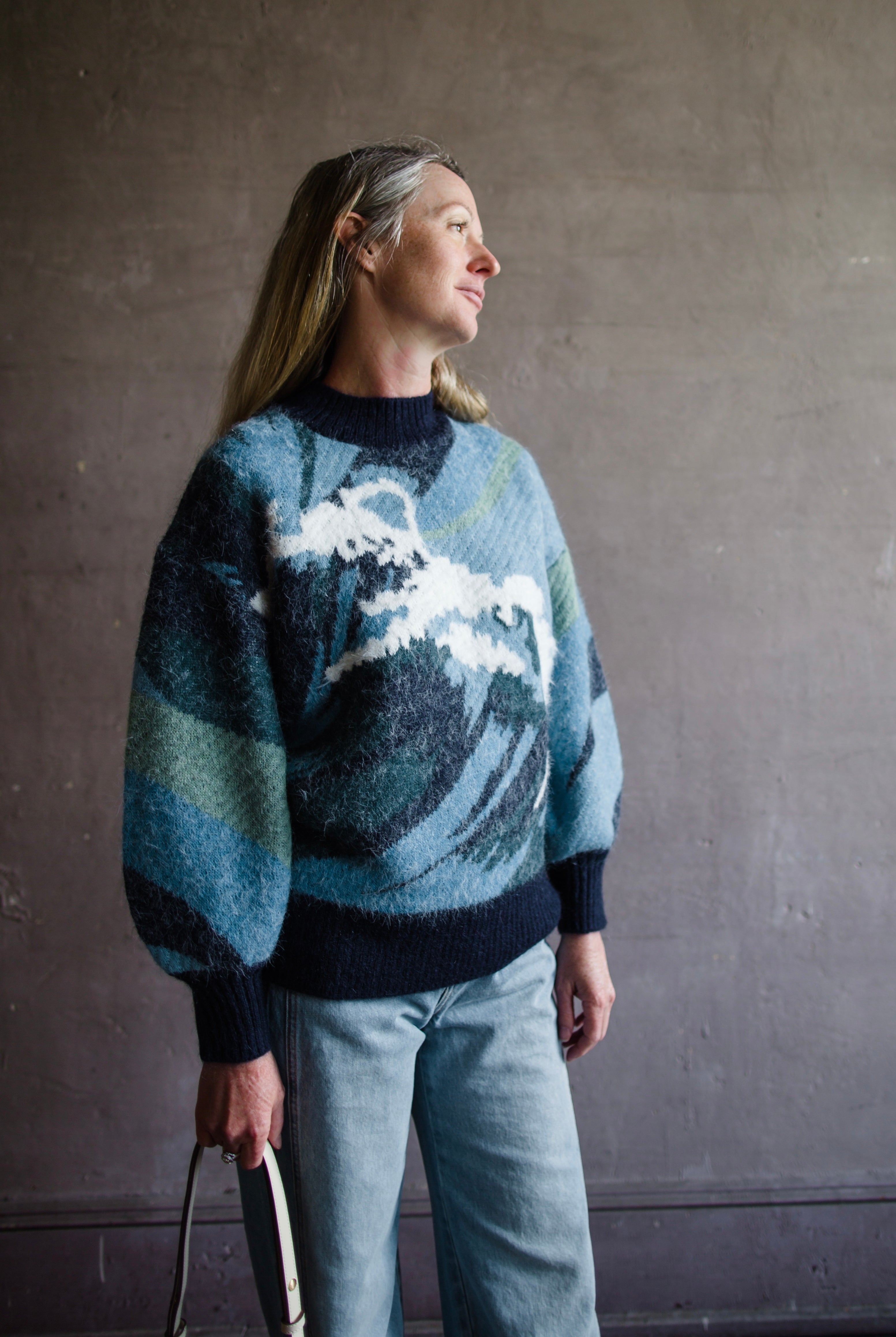 Image featuring a woman wearing the Wave knit sweater by Alemais with chunky texture with a wave pattern and full sleeves.