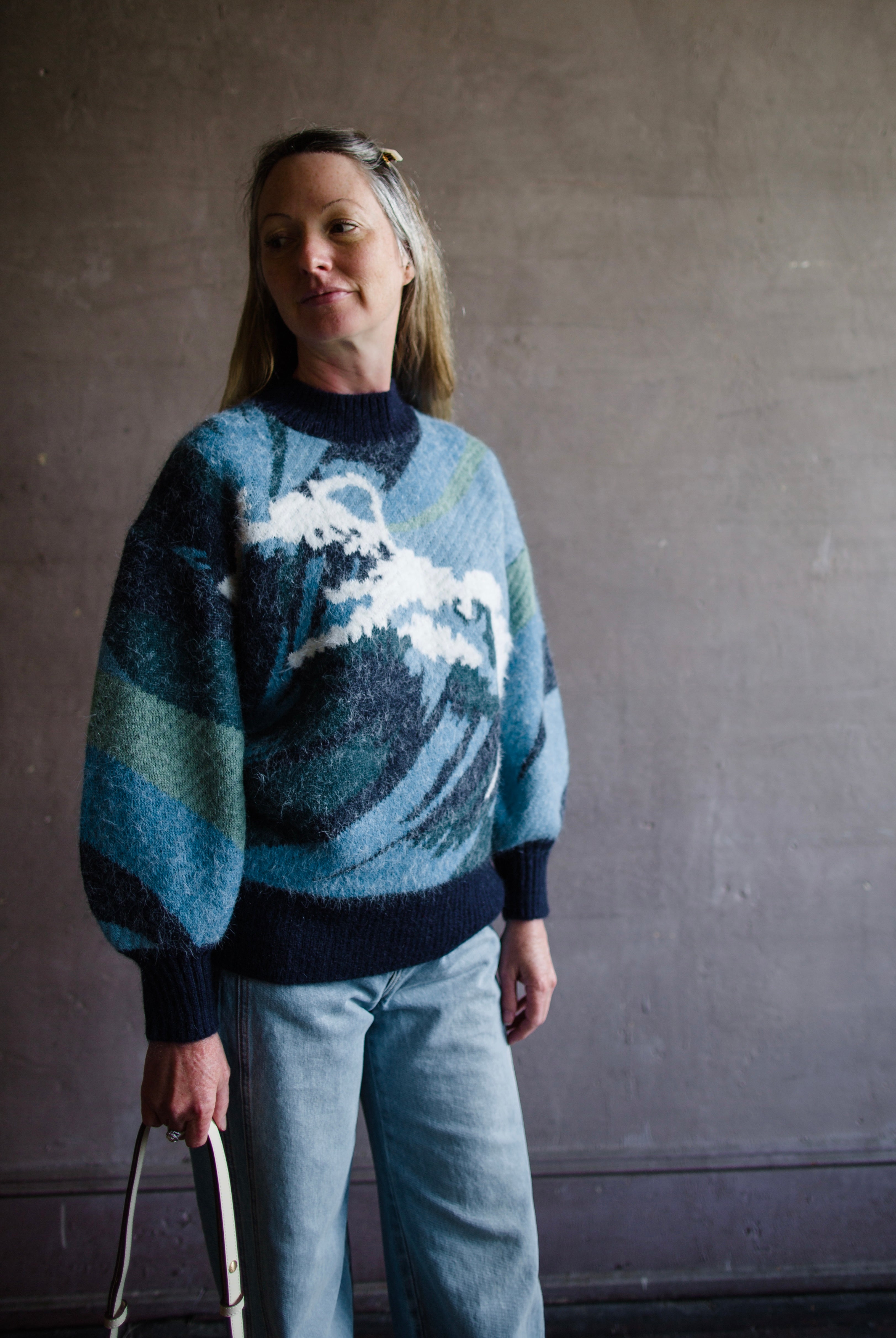 Image featuring a woman wearing the Wave knit sweater by Alemais with chunky texture with a wave pattern and full sleeves.