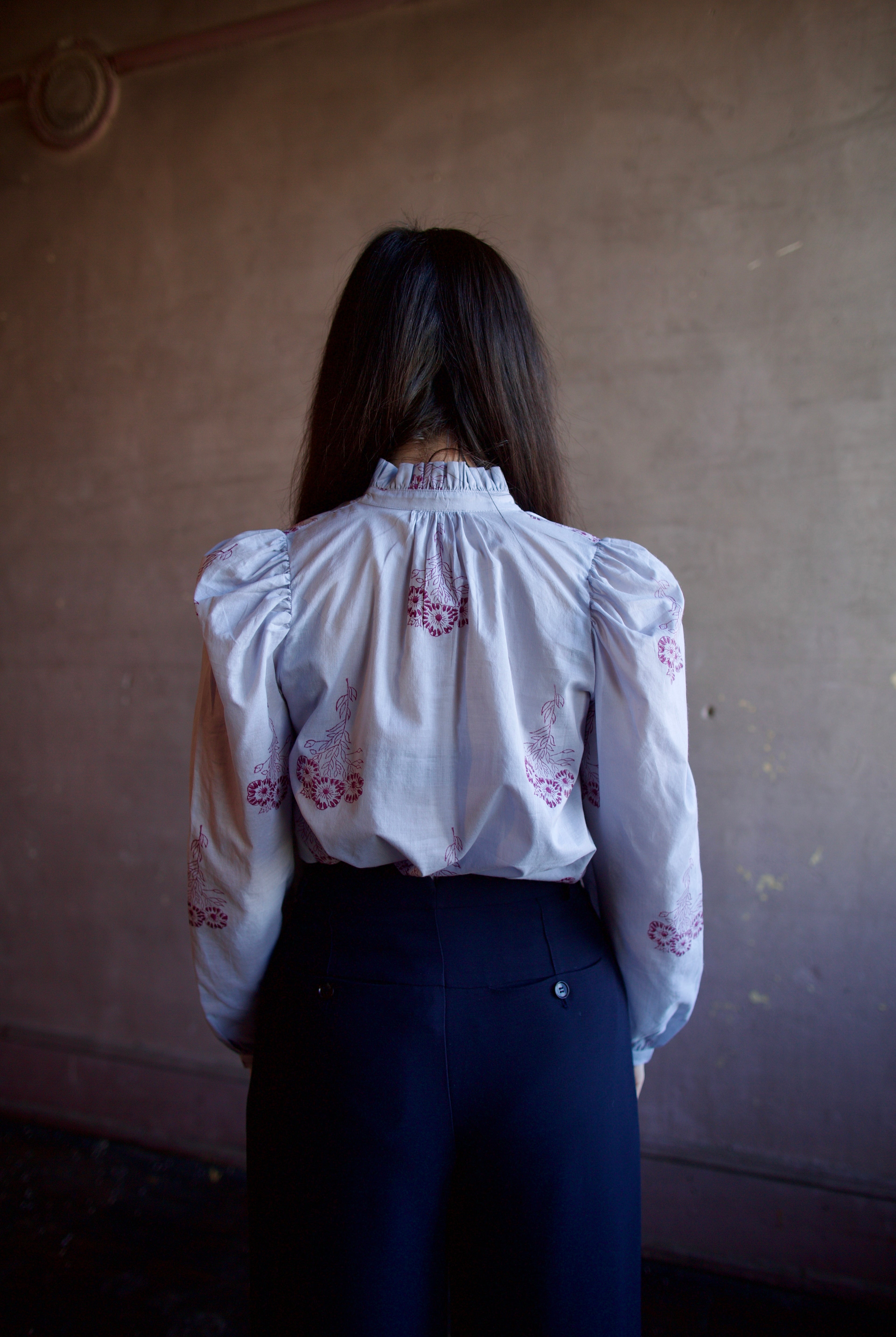 Woman wearing the alix of bohemia annabel pansy sky long sleeve cotton shirt expert handcrafted artistry perfect for elevated casual wear