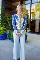 Model wearing luxury designer Alix of Bohemia Dorian jacket in blue marina bandana print with intricate details and feminine silhouette