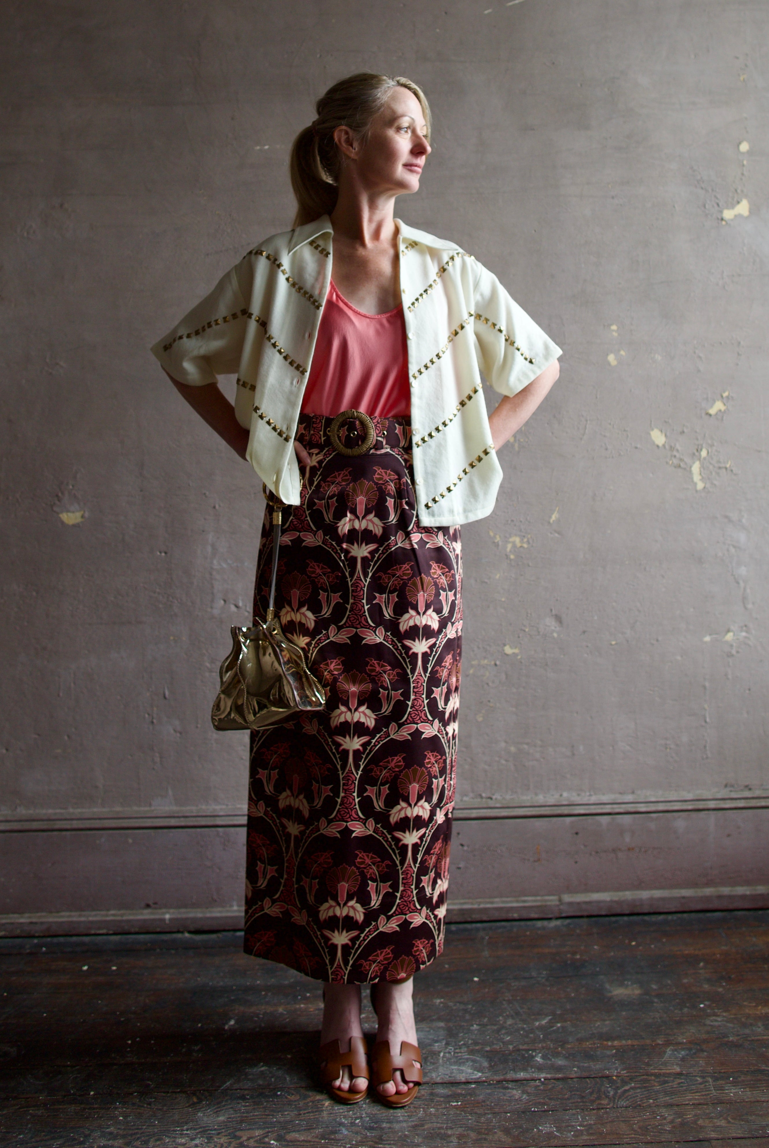 Image of a woman wearing the Alix of Bohemia Studded Shirt, Forte Forte Silk Tank and Cara Cara Printed Skirt