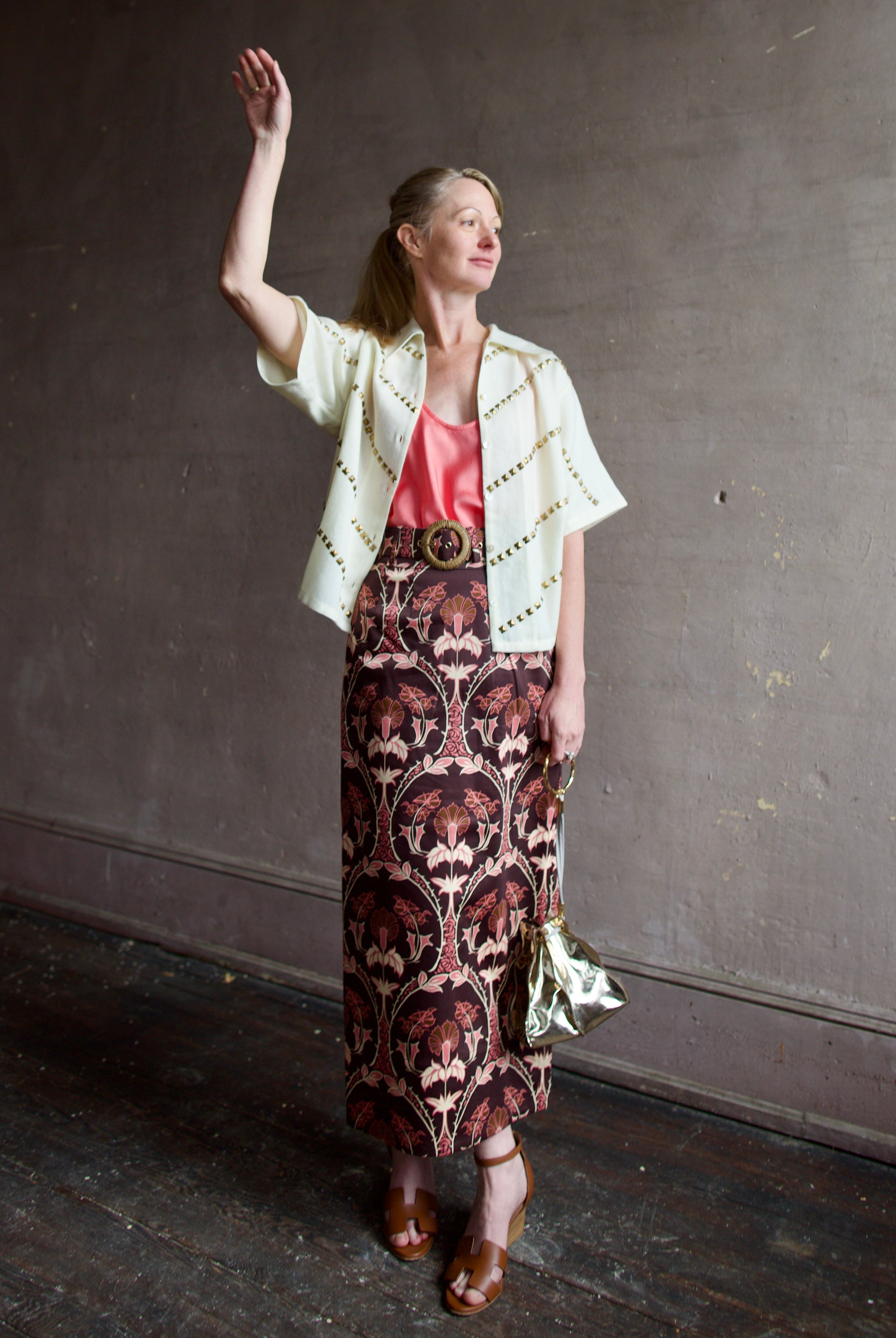 Image of a woman wearing the Alix of Bohemia Studded Shirt, Forte Forte Silk Tank and Cara Cara Printed Skirt