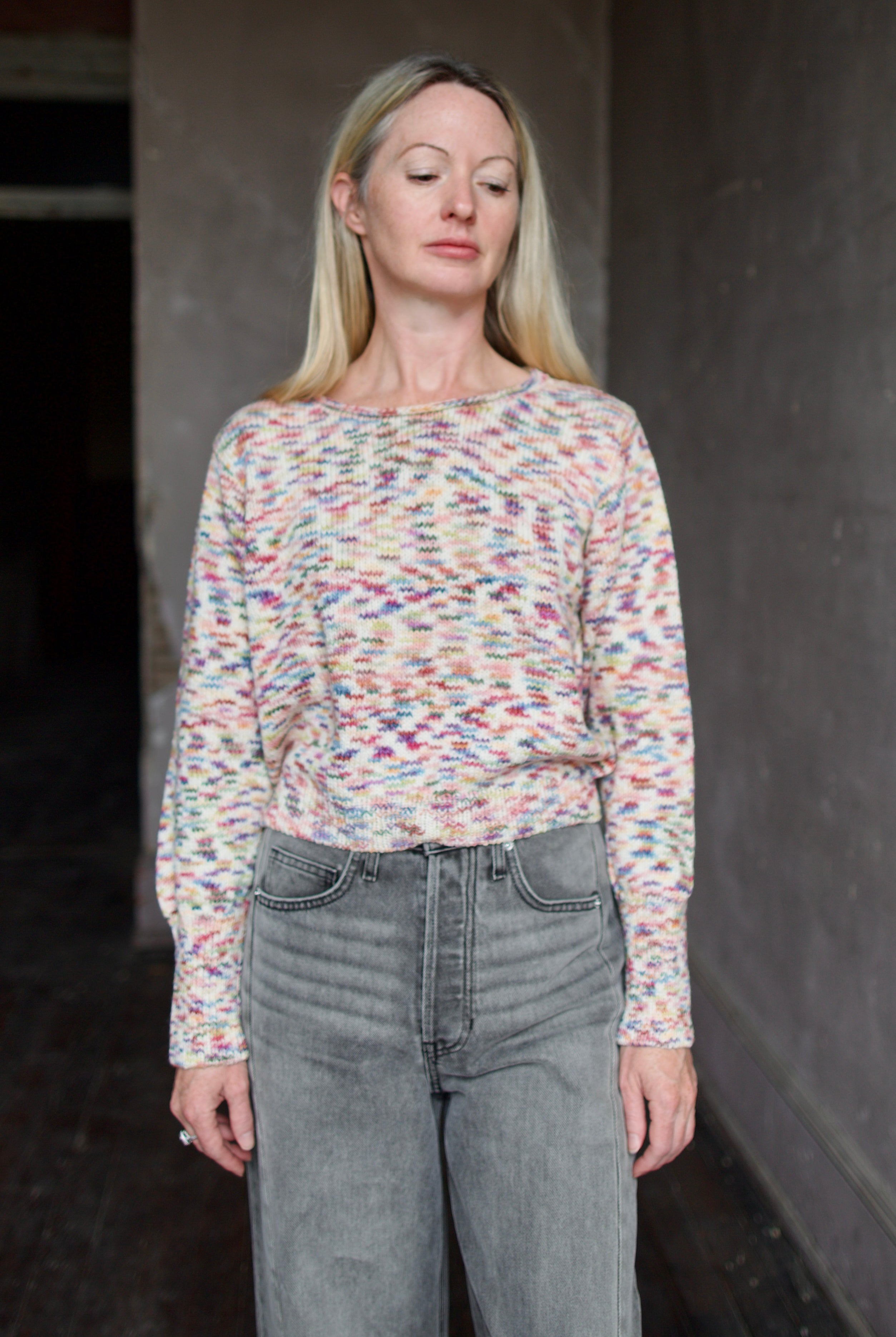 Model wearing an Alix of Bohemia colorful baby alpaca sweater and gray Veronica Beard barrel jeans