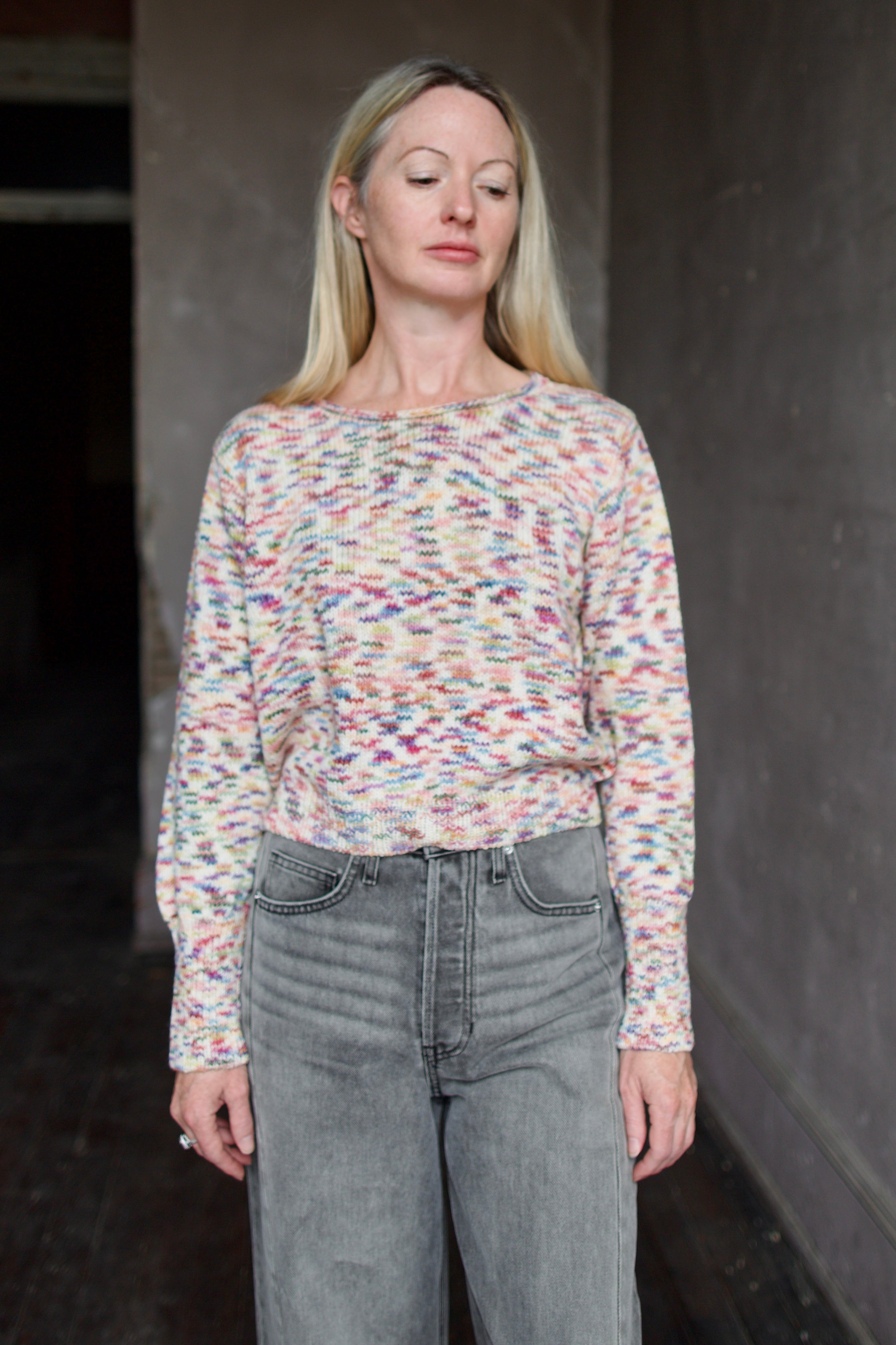 Model wearing an Alix of Bohemia colorful baby alpaca sweater and gray Veronica Beard barrel jeans