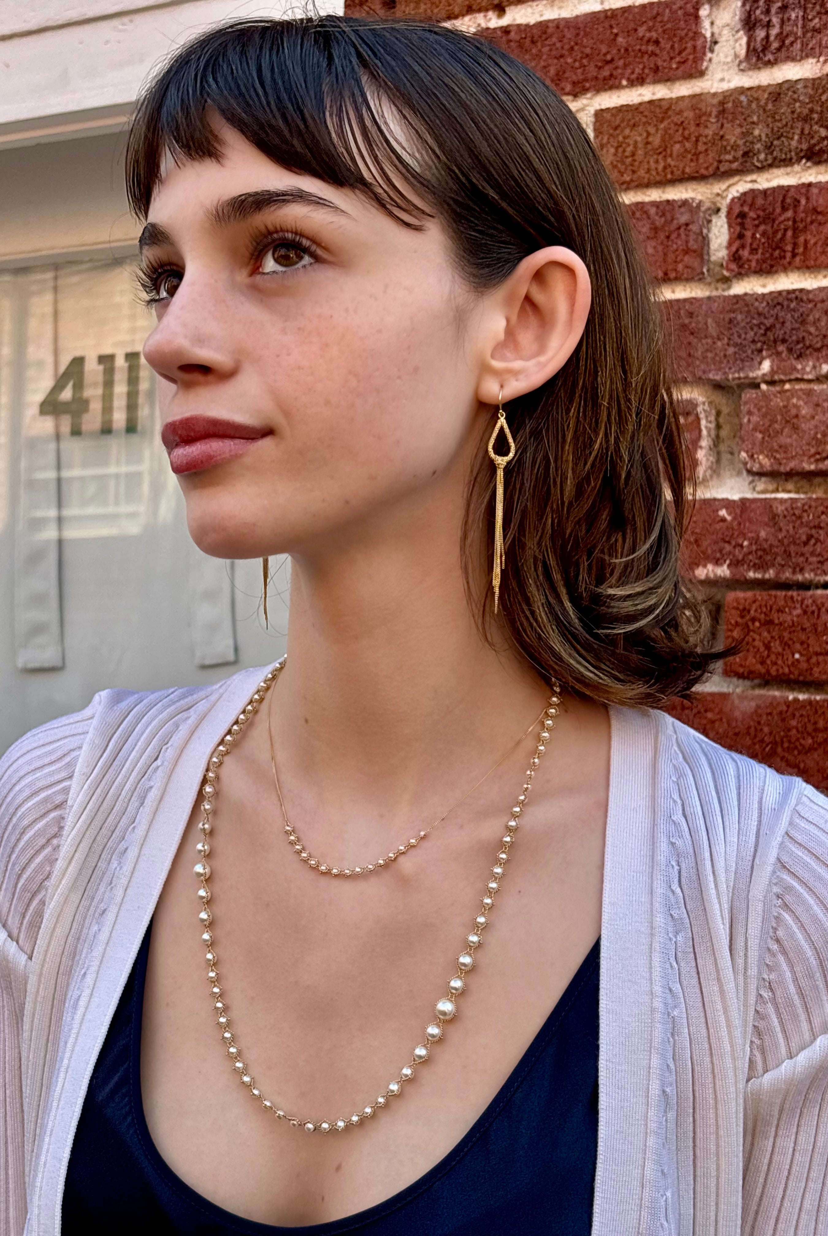 Woman wearing luxury designer Amali hand woven long Akoya Pearl and 18k yellow gold Necklace made in USA fine jewelry