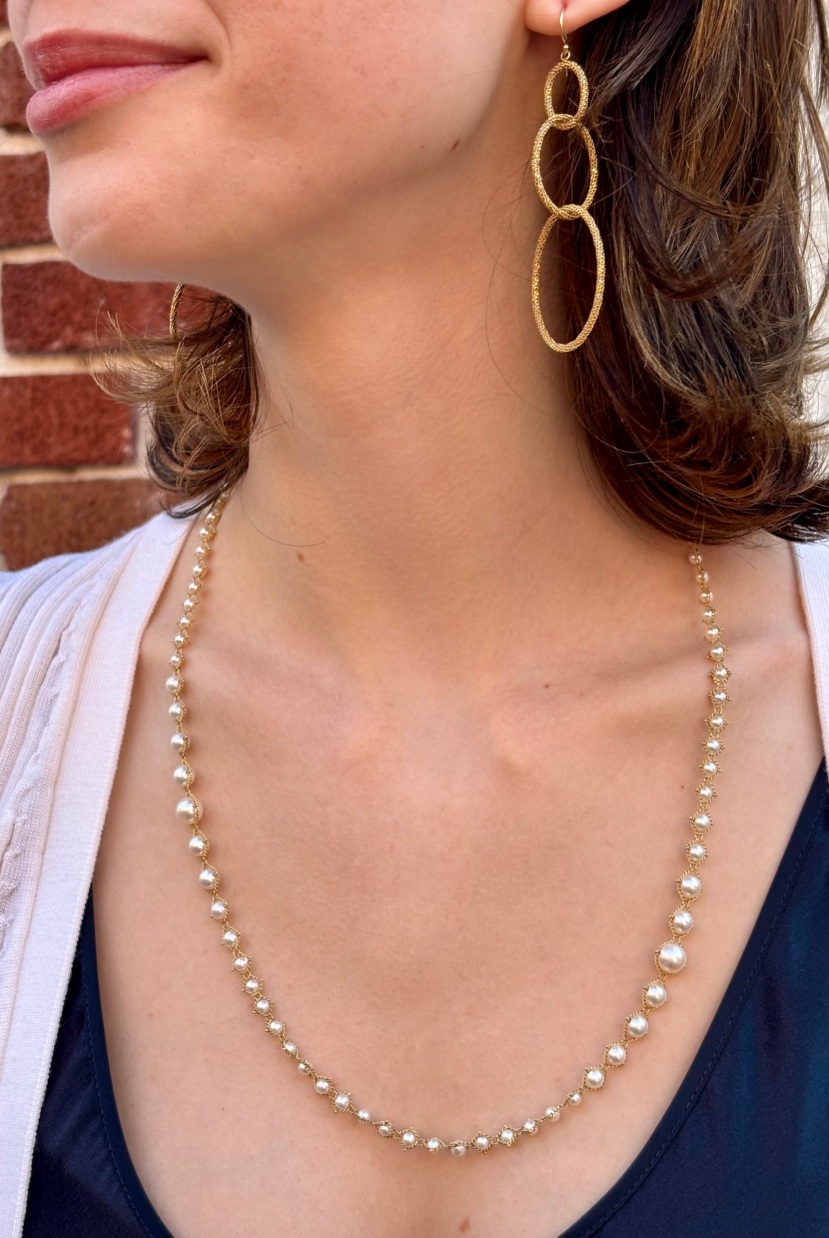 Woman wearing luxury designer Amali hand woven long Akoya Pearl and 18k yellow gold Necklace made in USA fine jewelry