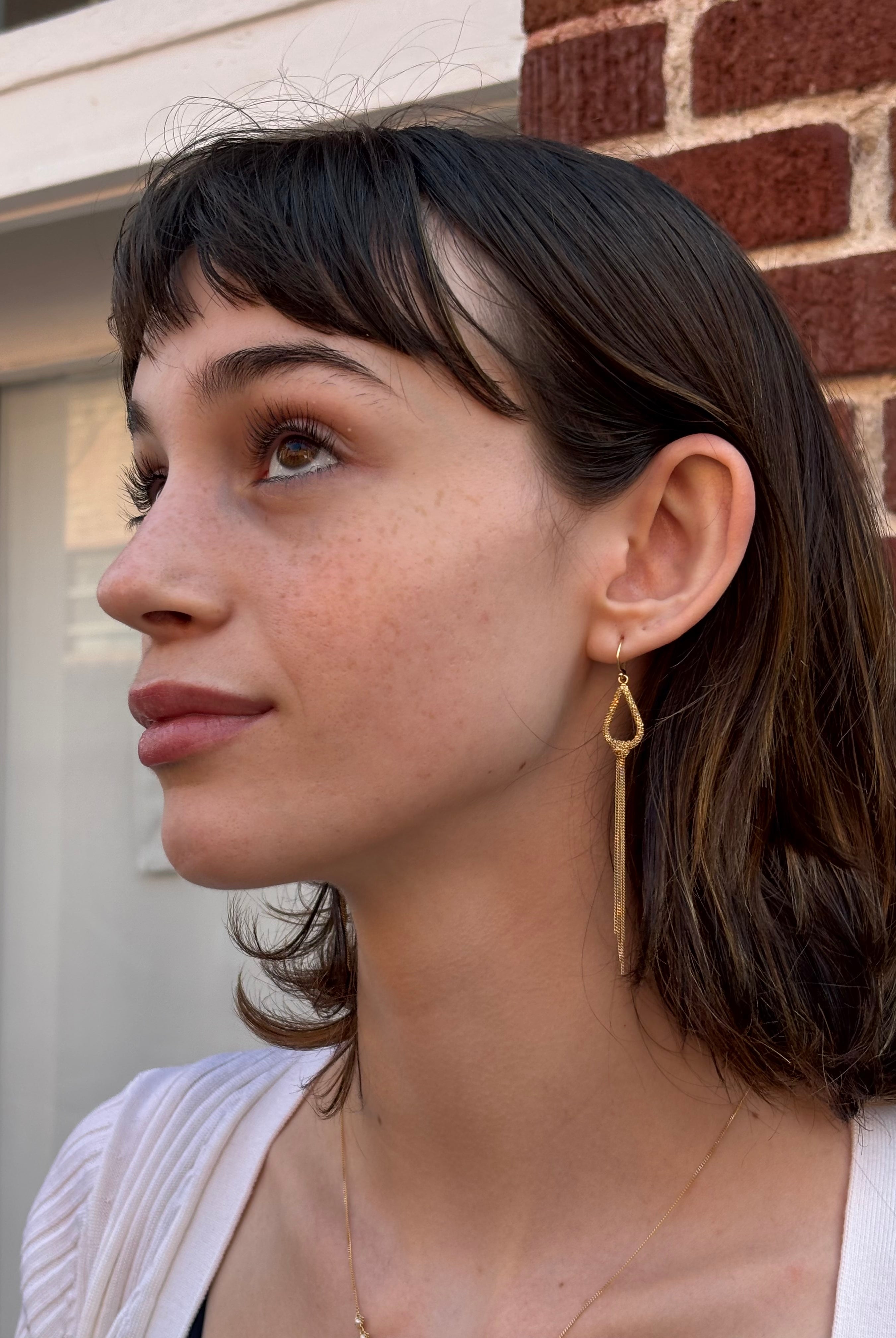 Woman wearing luxury designer Amali Knotted Marquis 18k yellow gold Earrings made in USA Fine Jewelry