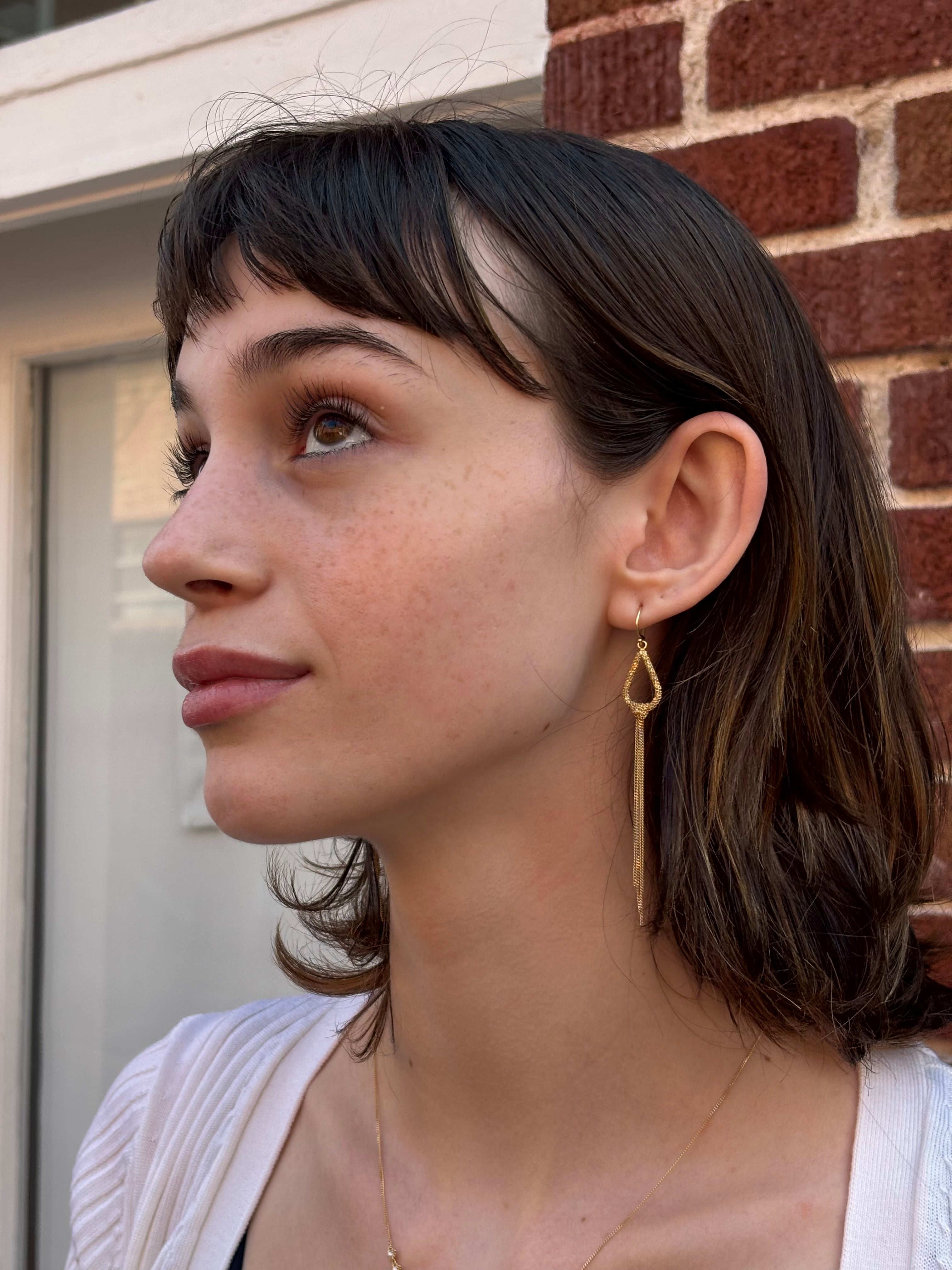 Woman wearing luxury designer Amali Knotted Marquis 18k yellow gold Earrings made in USA Fine Jewelry