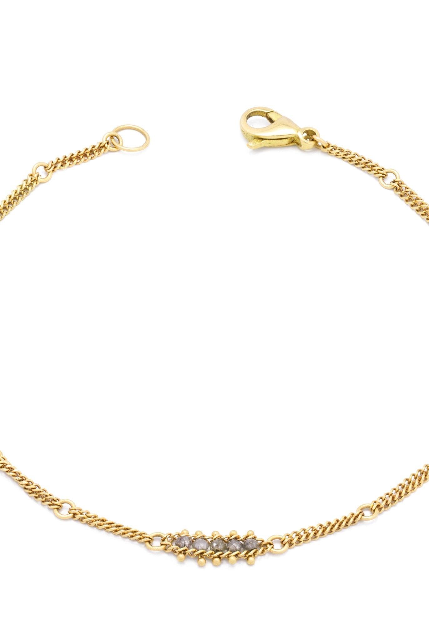 Woman wearing silver diamond and yellow gold bracelet with 5 diamond groupings all the way around by US fine jewelry designer Amali. A stylish modern take on a classic