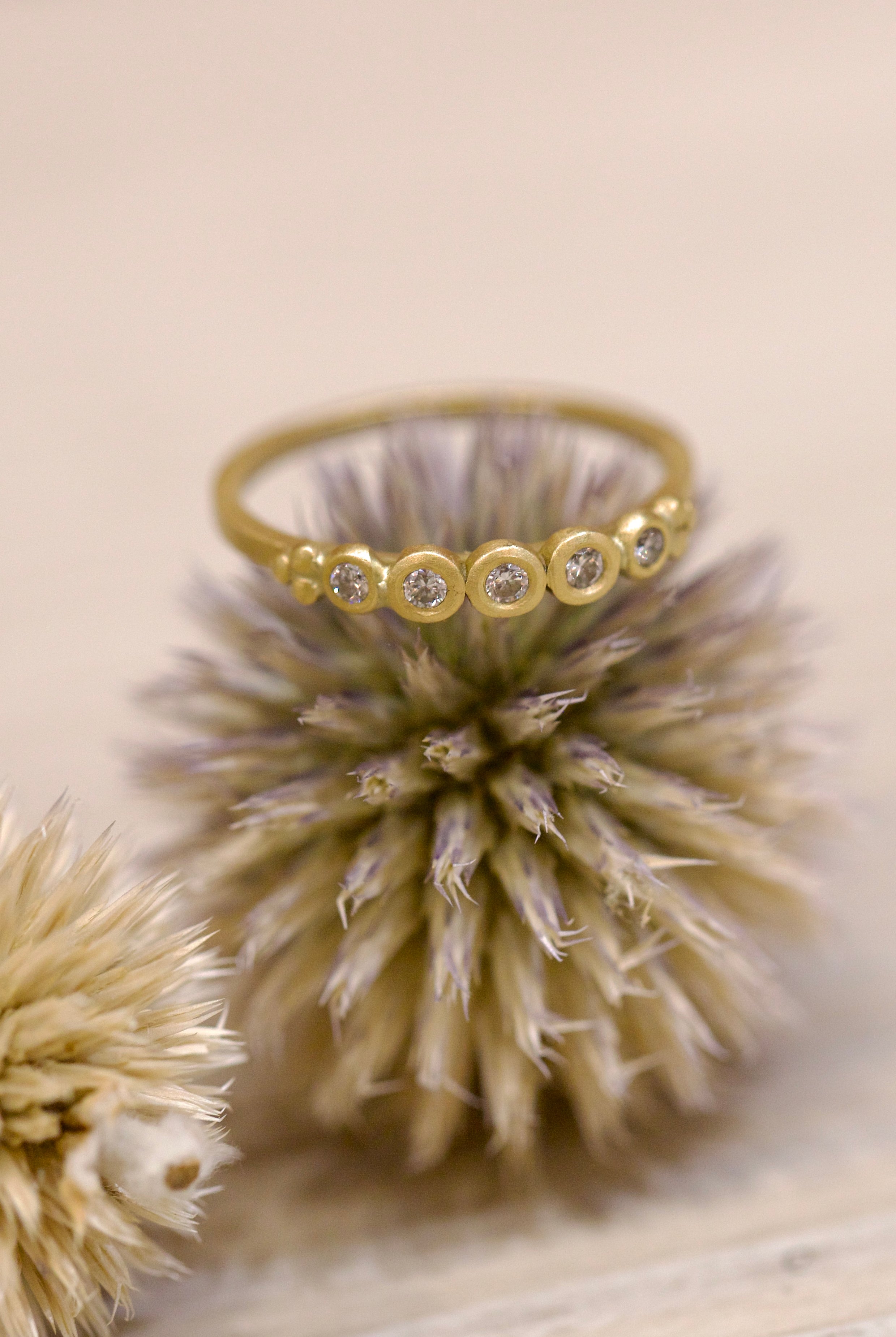 Image of Ananda Khalsa handmade 18kt hammered matte gold ring featuring five white diamond setting expertly crafted