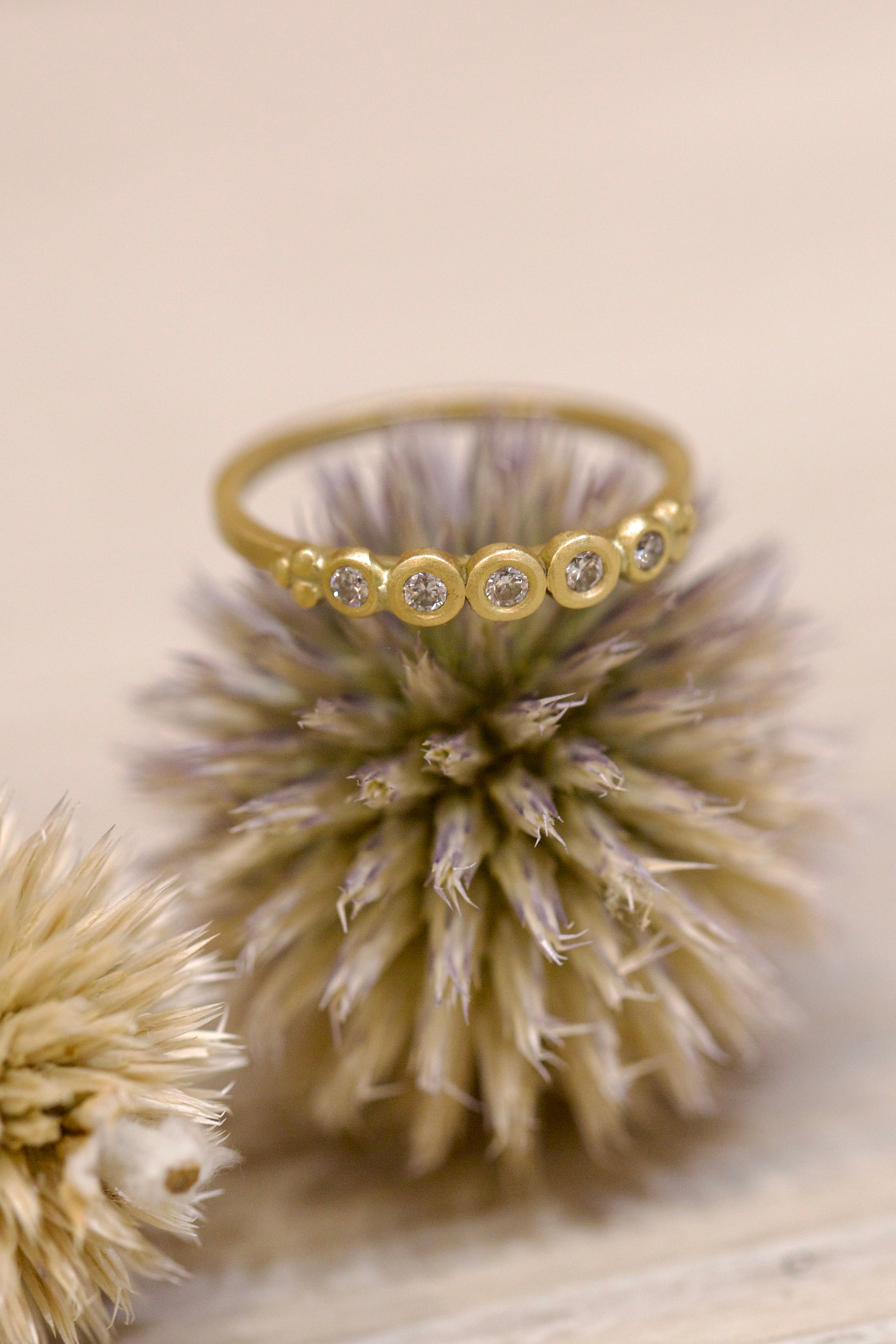 Image of Ananda Khalsa handmade 18kt hammered matte gold ring featuring five white diamond setting expertly crafted