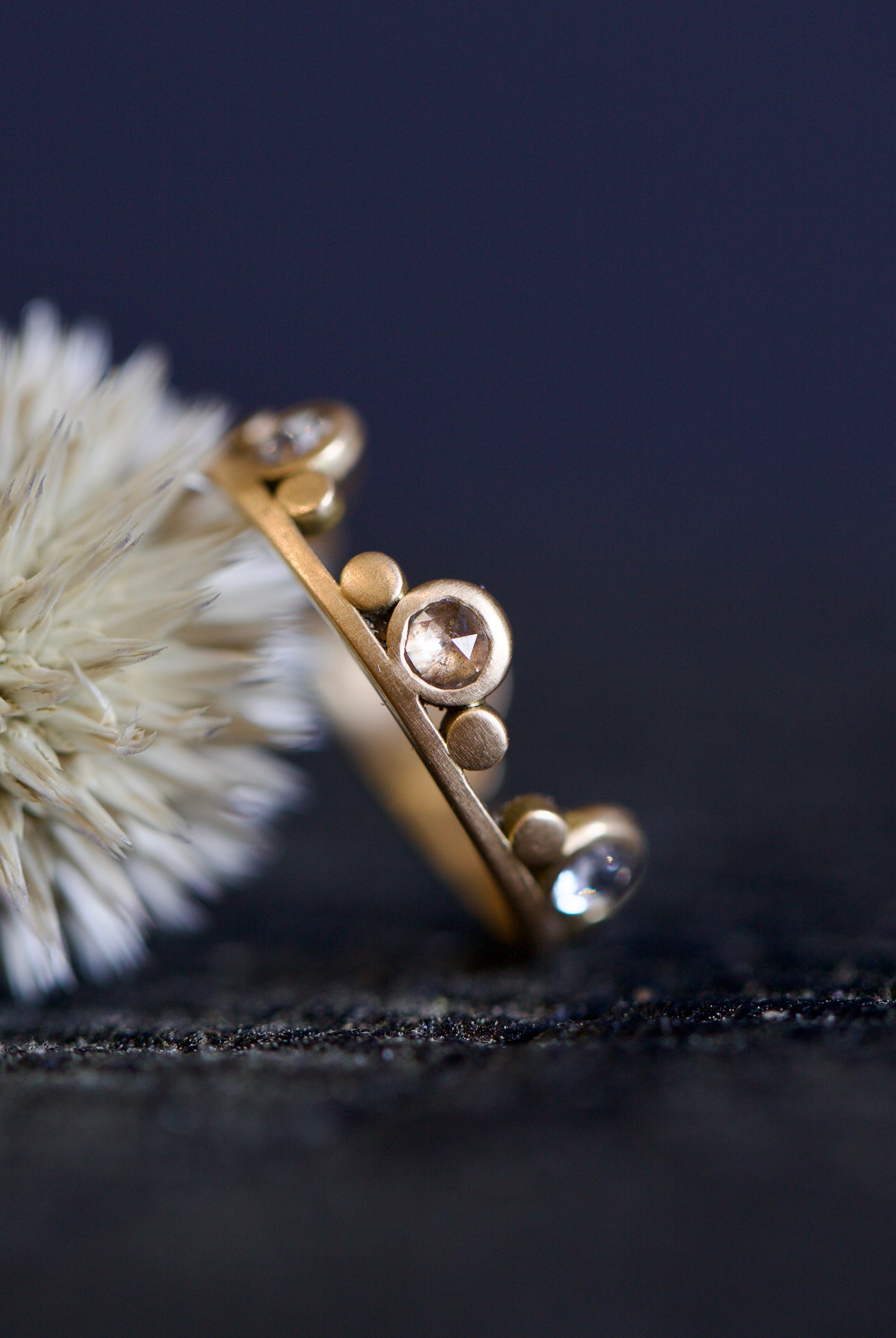 Image featuring fine jeweler Ananda Khalsa Large White Diamond 18k hammered matte Gold Side Trios Ring in premium handcrafted construction