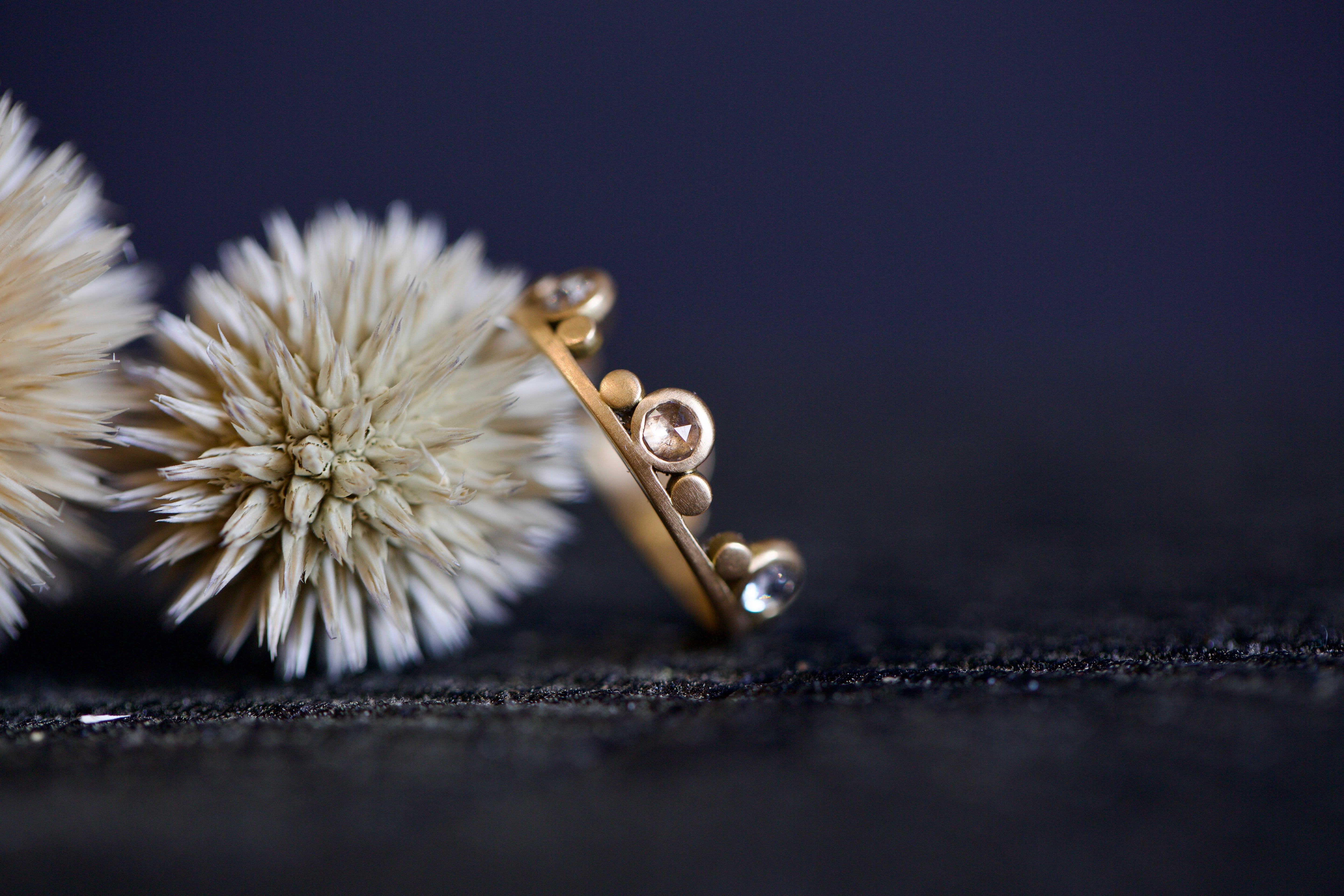 Image featuring fine jeweler Ananda Khalsa Large White Diamond 18k hammered matte Gold Side Trios Ring in premium handcrafted construction