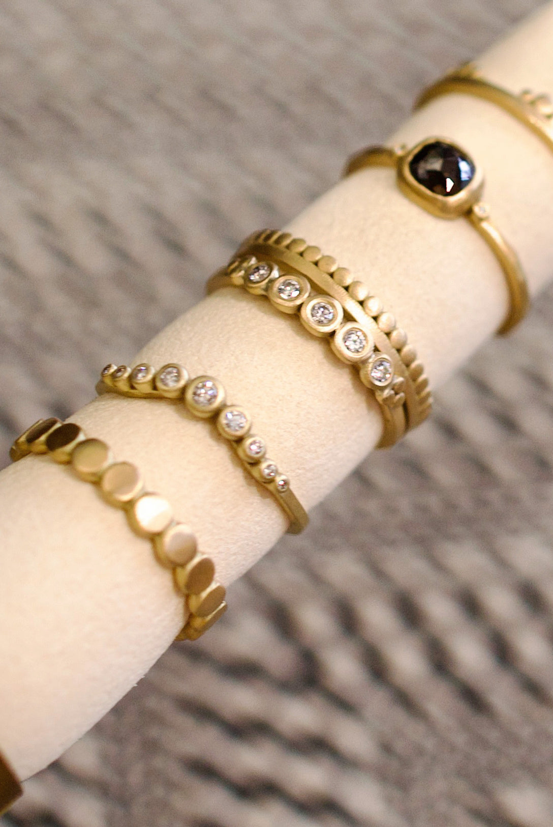 Image of Ananda Khalsa handmade 18kt hammered matte gold ring featuring five white diamond setting expertly crafted