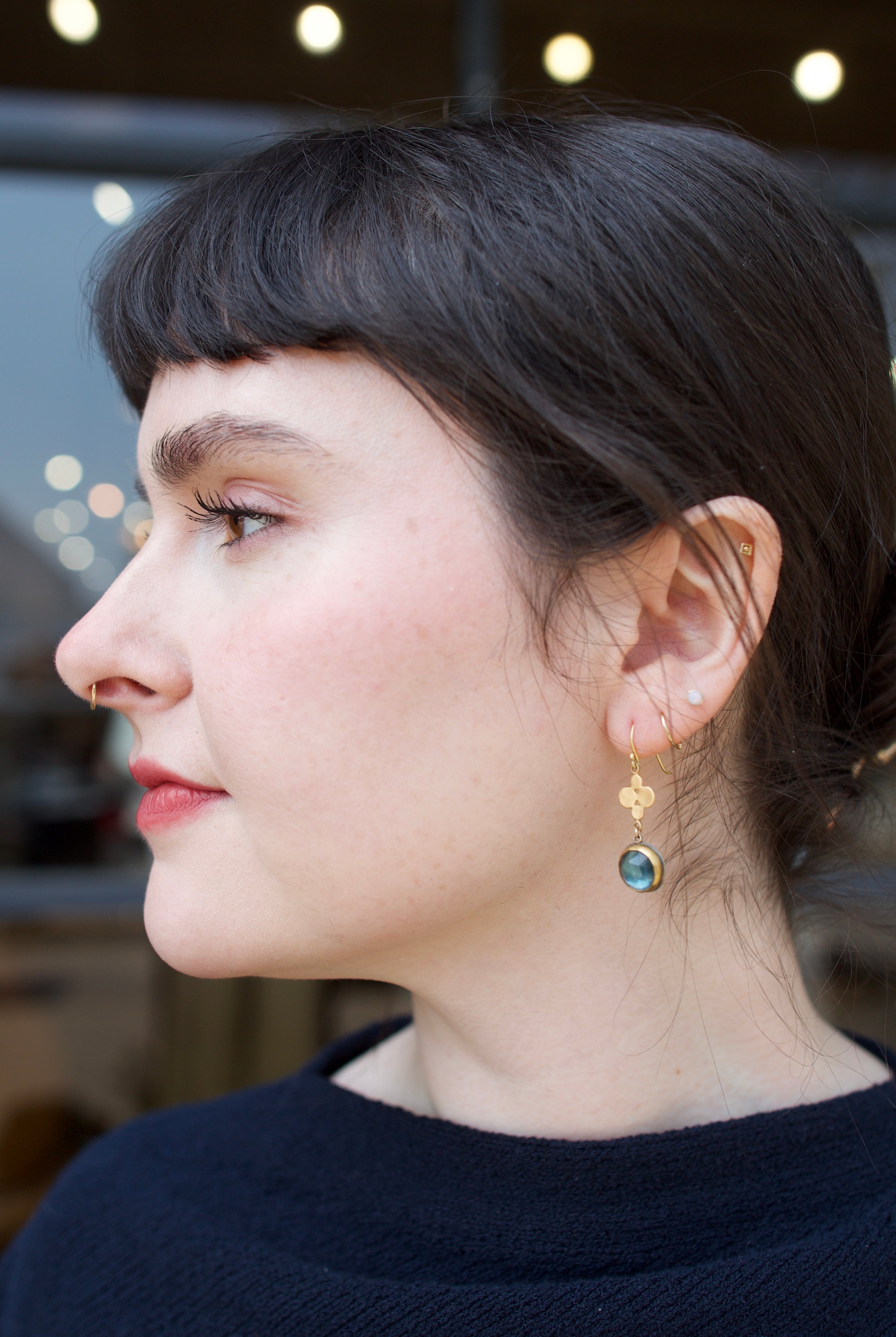 Image of fine jeweler Ananda Khalsa Rosecut London Blue Topaz Drop Earrings with 22kt gold bezel setting and multi-dot charms