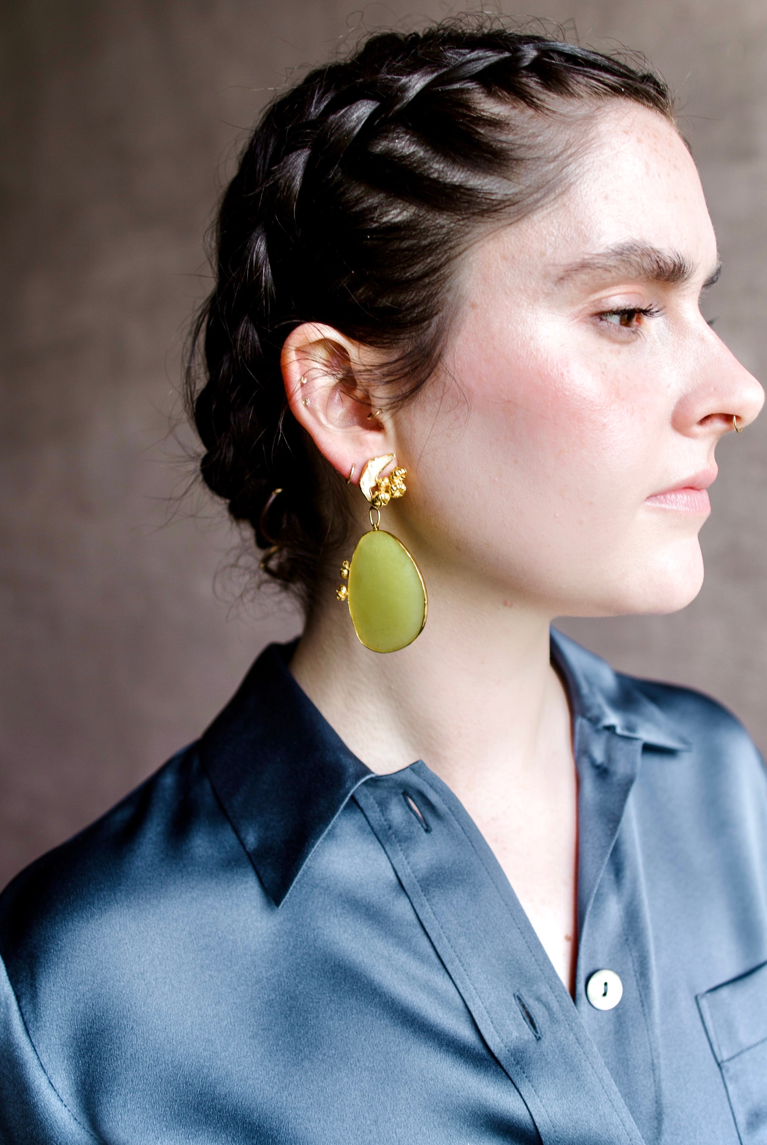 Image featuring a woman wearing handmade earrings by North Carolina artist Anna Johnson with Lemon quartz, rodent mandibles, 18k gold vermeil over silver