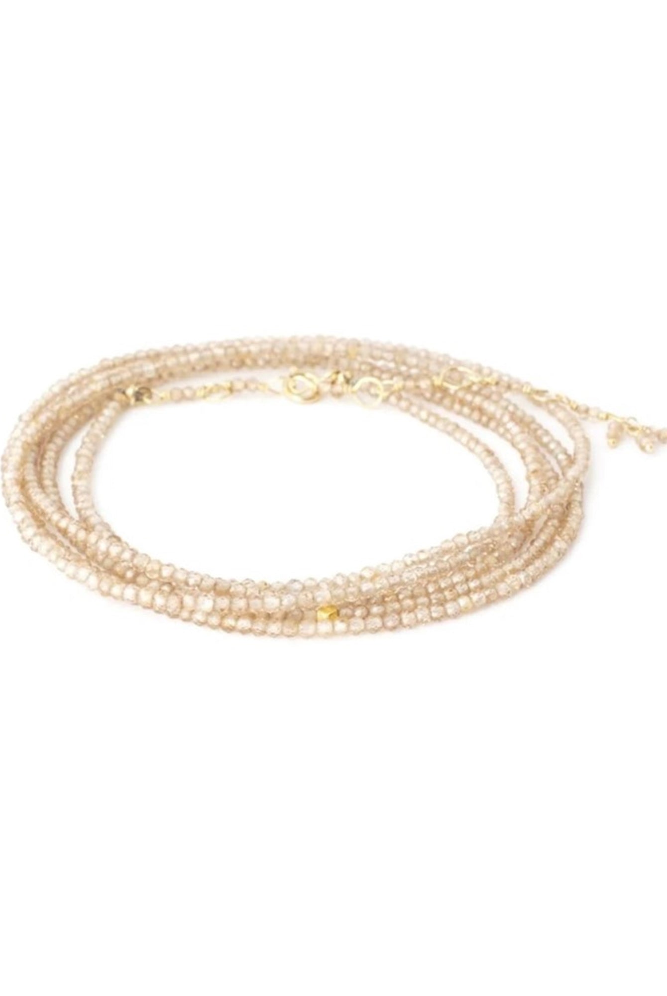 Image featuring a handmade brown zircon bracelet by Anne Sportun that can be worn as a bracelet or necklace with 18k yellow gold.