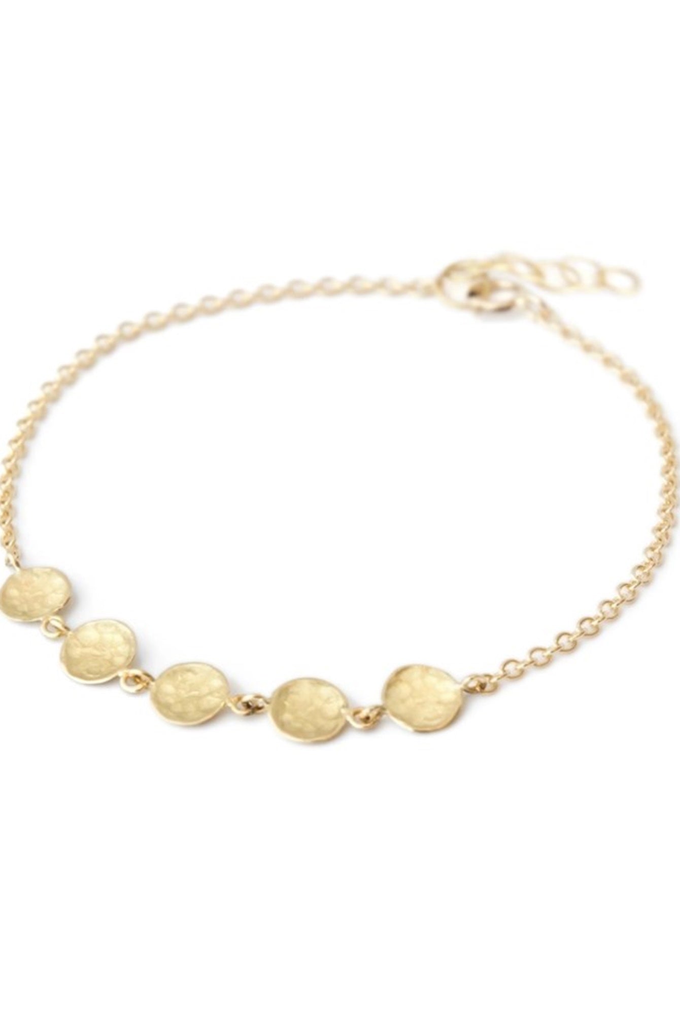Image featuring bracelet by artist Anne Sportun fabricated in 18k yellow gold with 5 hammered gold discs