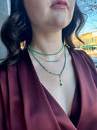 Image of woman wearing fine jewelry designer ANNE SPORTUN Centre Turquoise and 18k yellow gold Wrap Necklace