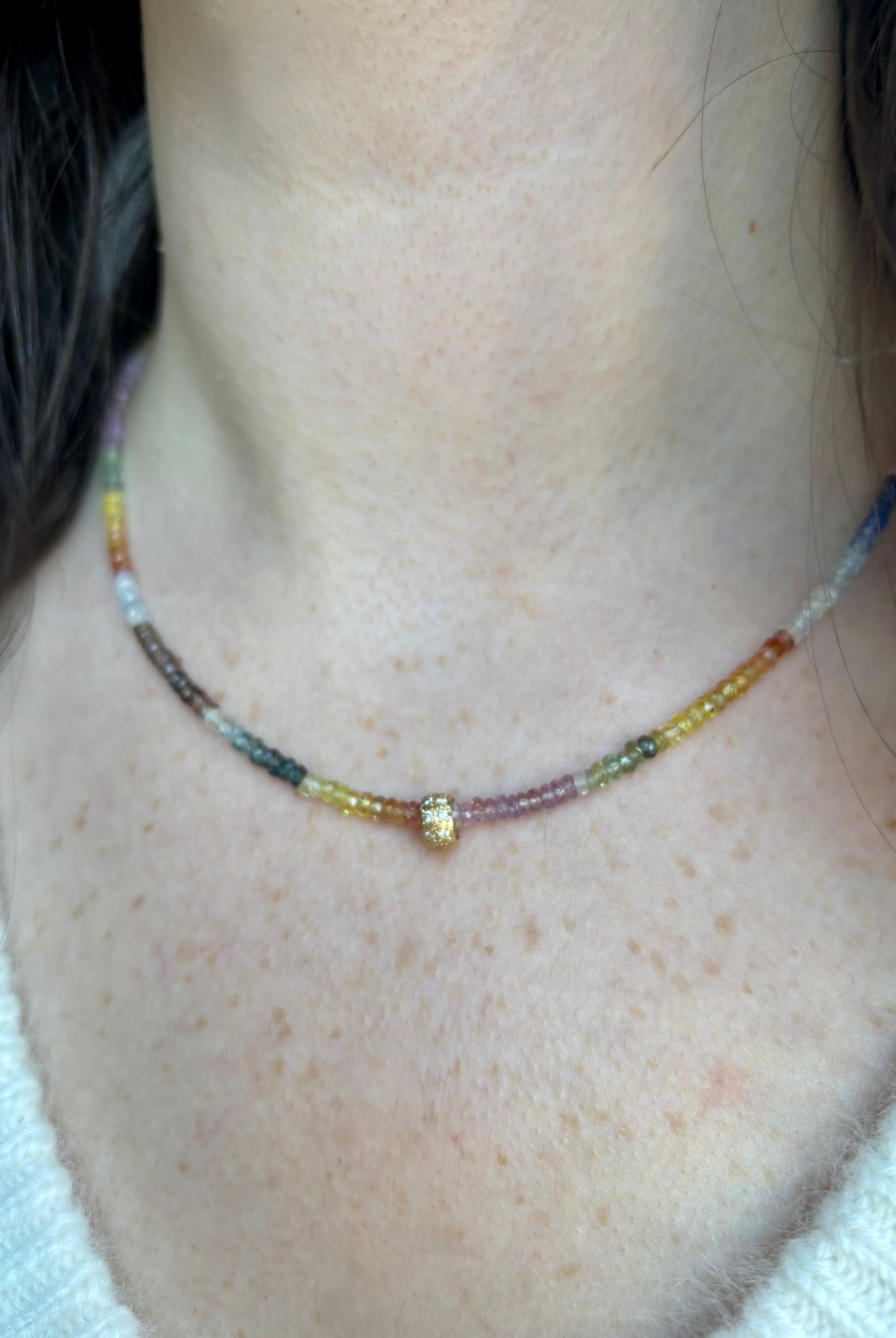 Close up image of woman wearing fine jewelry designer ANNE SPORTUN Multi-Sapphire and Diamond Necklace in 18K Yellow Gold
