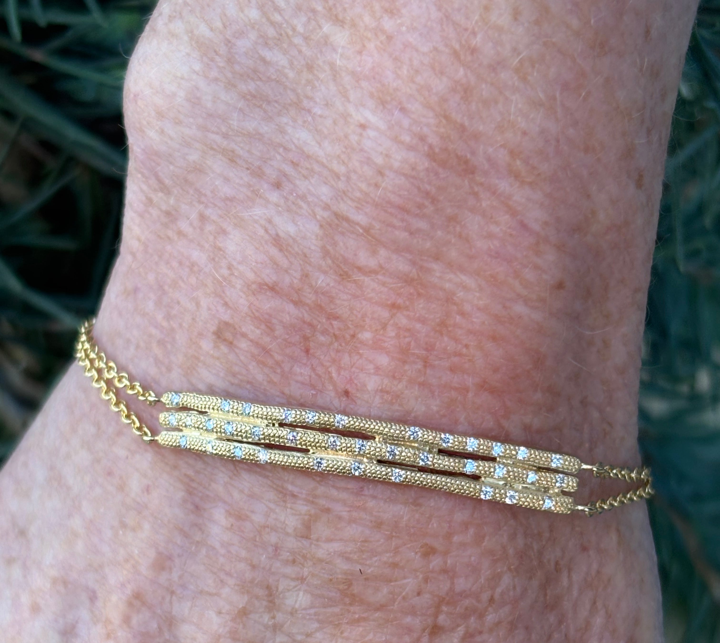 Image of woman wearing fine jewelry designer ANNE SPORTUN Stardust Triple Stick Bracelet in 18K Yellow Gold and Diamonds with an adjustable clasp