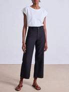 Model wearing expertly tailored Apiece Apart Merida high rise black pants with belt loops and front zip