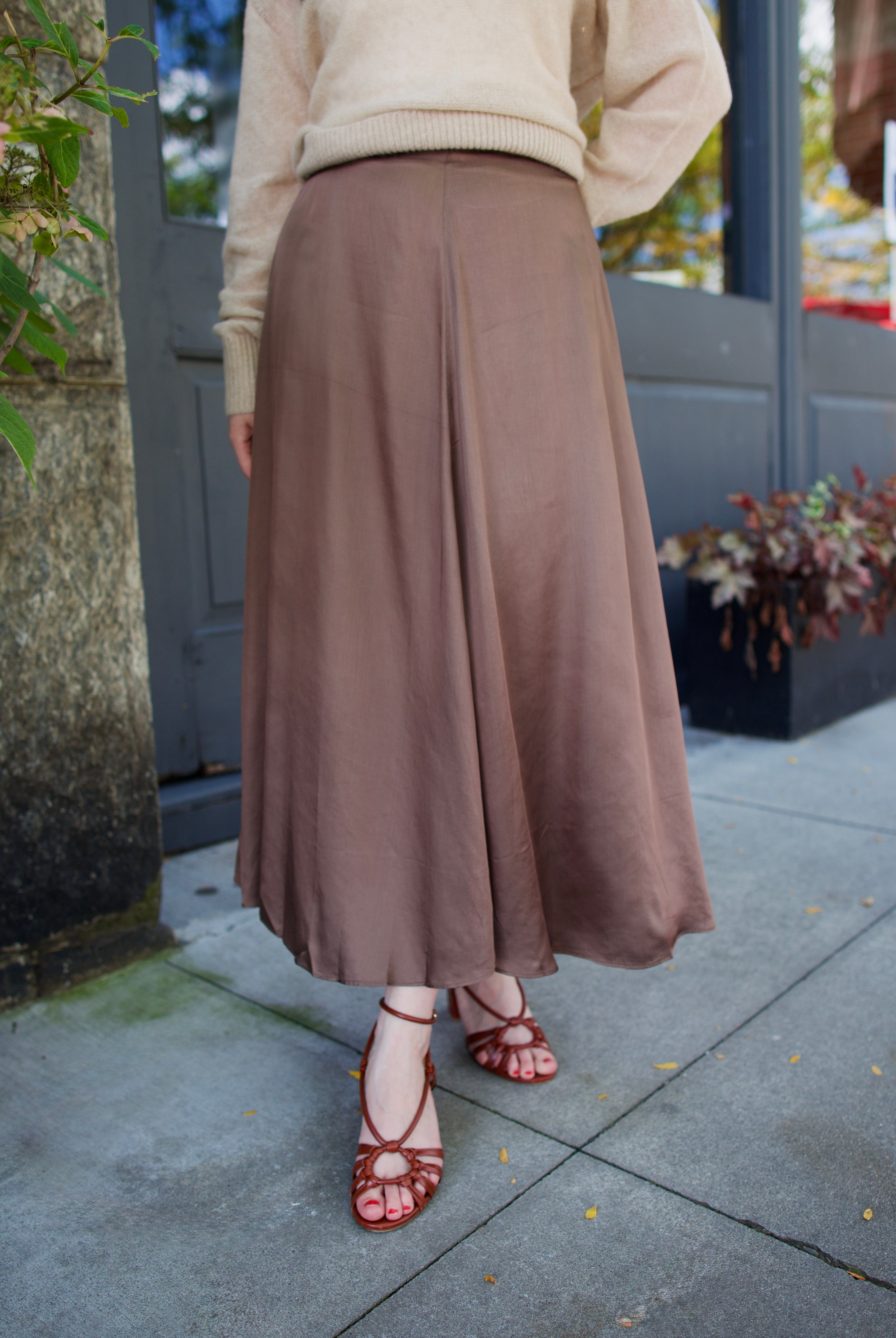 Model wearing a timeless classic tailoring Primavera skirt in a sophisticated neutral by Apiece Apart