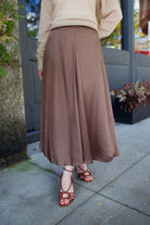 Model wearing a timeless classic tailoring Primavera skirt in a sophisticated neutral by Apiece Apart