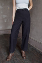 Model wearing expertly tailored Apiece Apart Merida black pants that are your new go to
