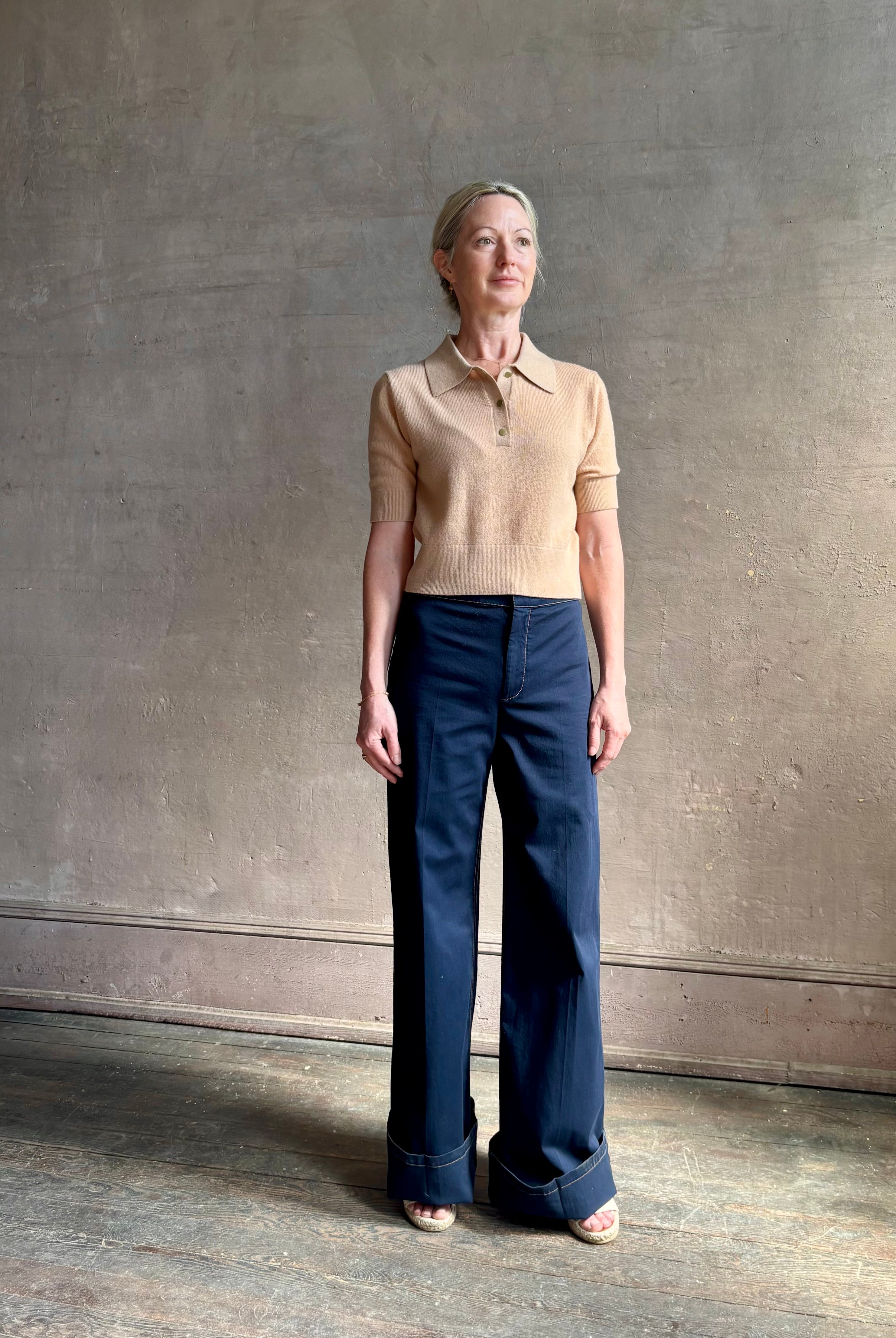 Mature woman wearing the European tailored Jane Pant from Callas rendered in a timeless navy and crafted from a stretchy cotton blend featuring yellow stitching, a clean flat front and flattering back pockets