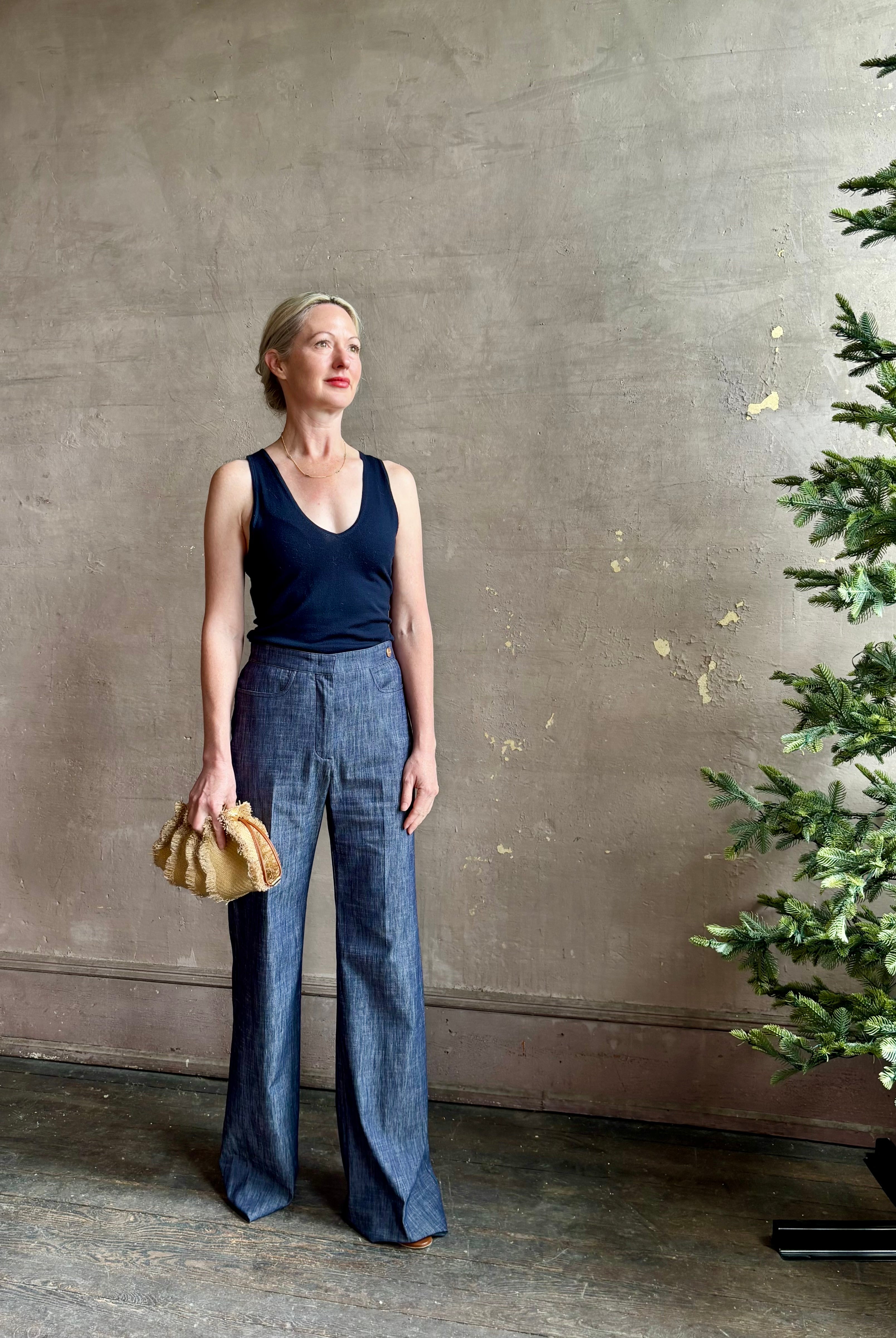 Mature woman wearing Italian designer Tonne trouser from Callas rendered in a dark indigo and crafted from a viscose, polyester, and linen blend with beautiful fluid draping and effortless versitility similar to denim