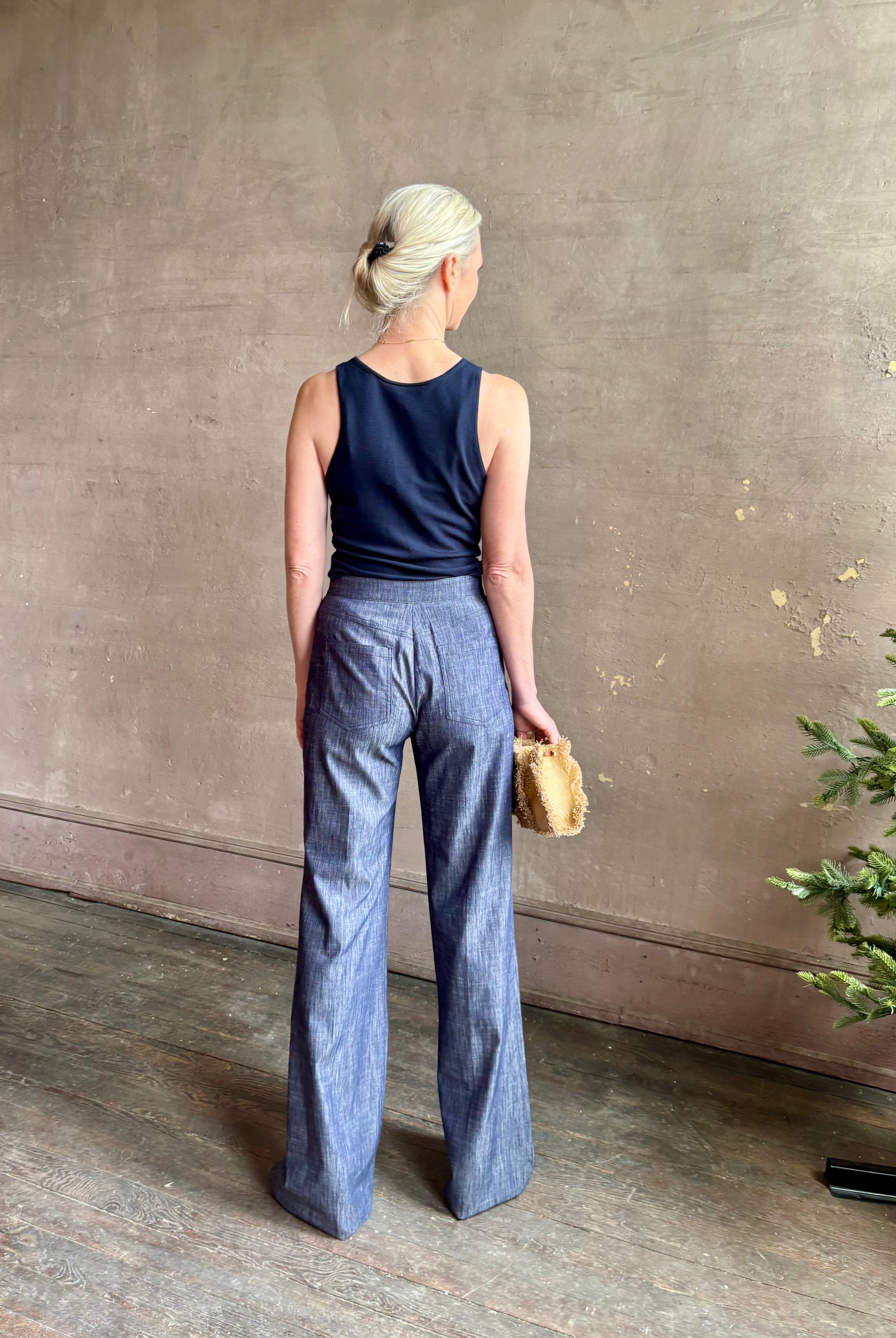 Mature woman wearing Italian designer Tonne trouser from Callas rendered in a dark indigo and crafted from a viscose, polyester, and linen blend with beautiful fluid draping and effortless versitility similar to denim