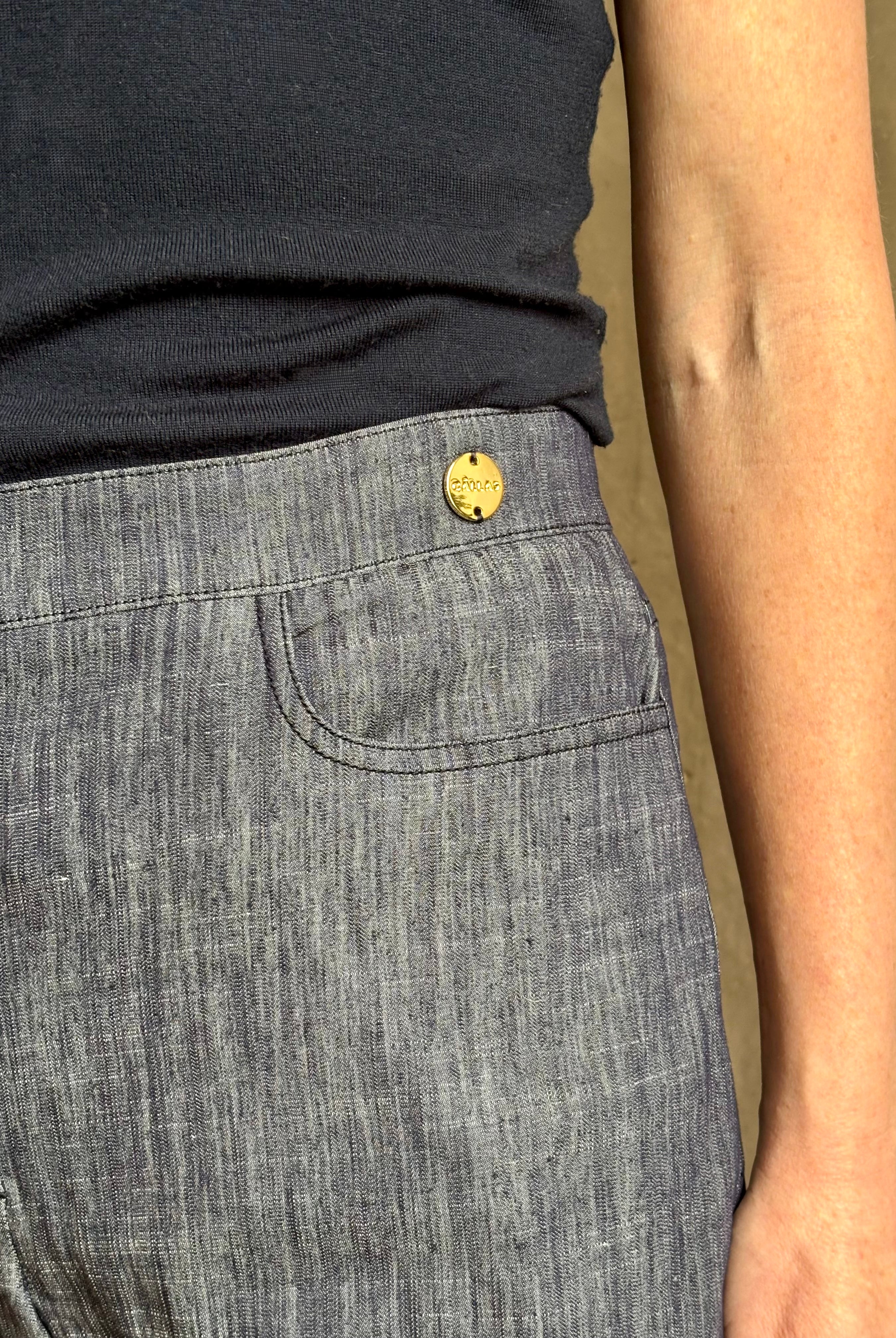 Mature woman wearing Italian designer Tonne trouser from Callas rendered in a dark indigo and crafted from a viscose, polyester, and linen blend with beautiful fluid draping and effortless versitility similar to denim