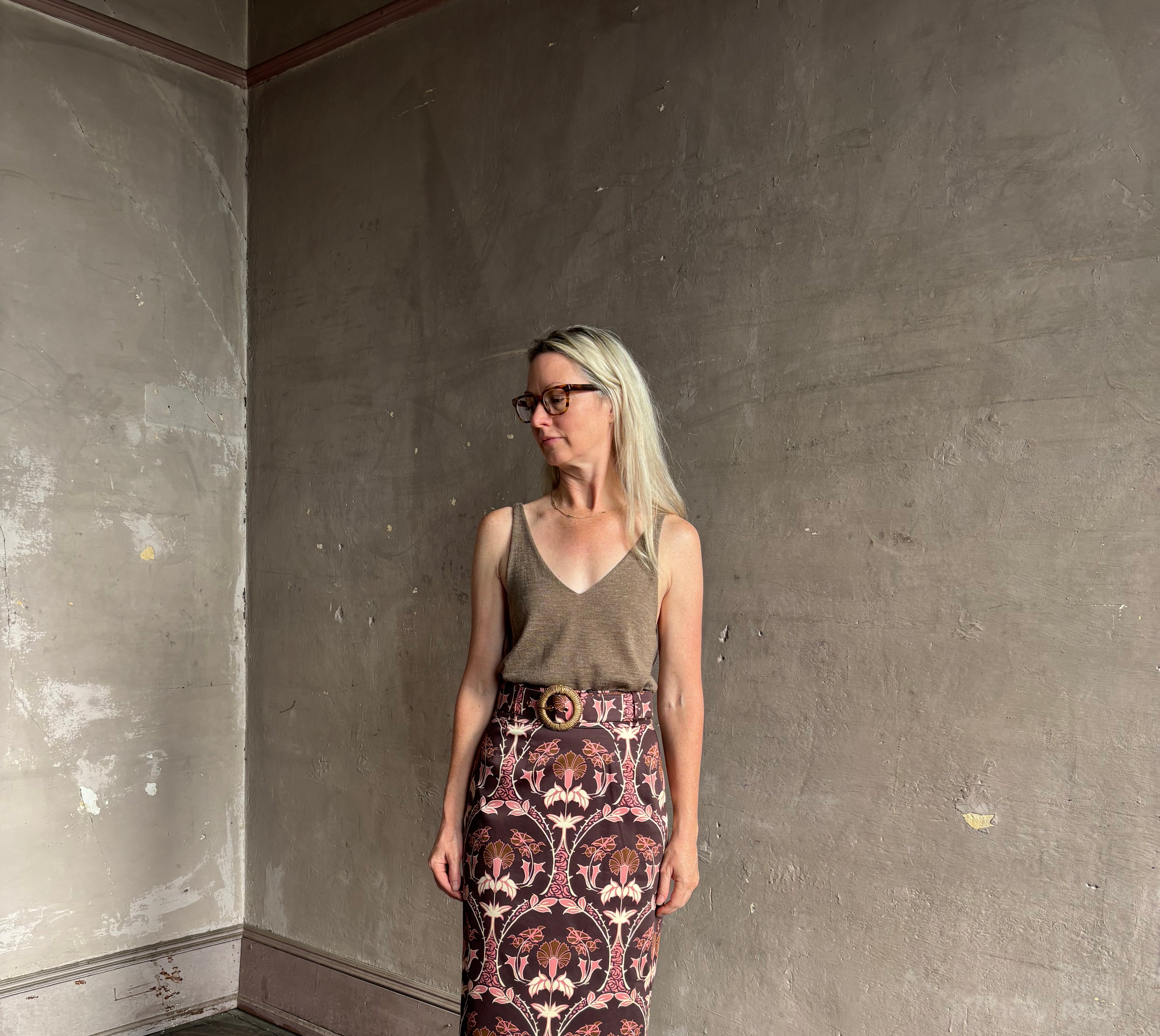 Mature woman wearing Cara Cara blaze long pencil skirt with a brown pink and beige botanical damask pattern