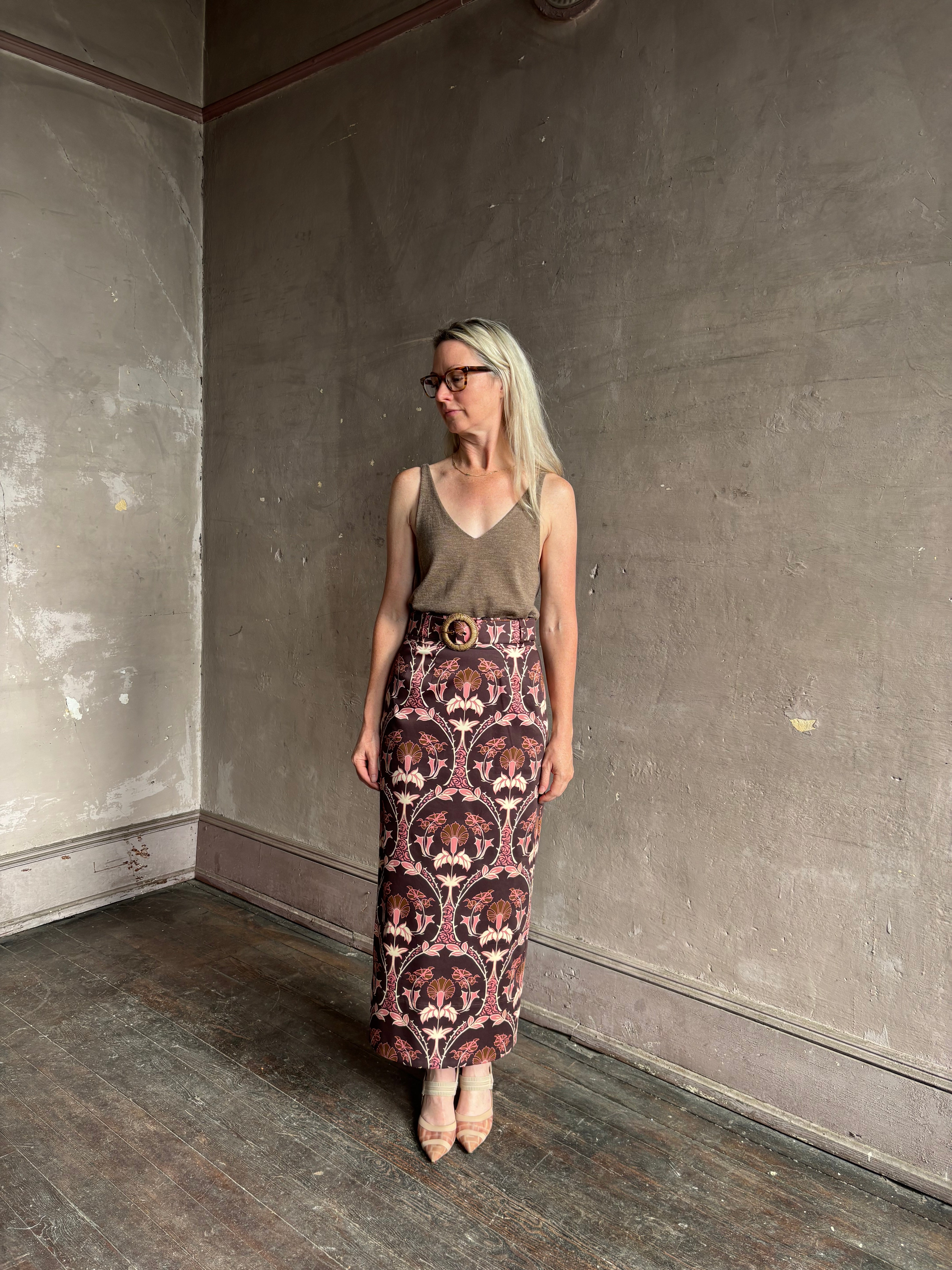 Mature woman wearing Cara Cara blaze long pencil skirt with a brown pink and beige botanical damask pattern
